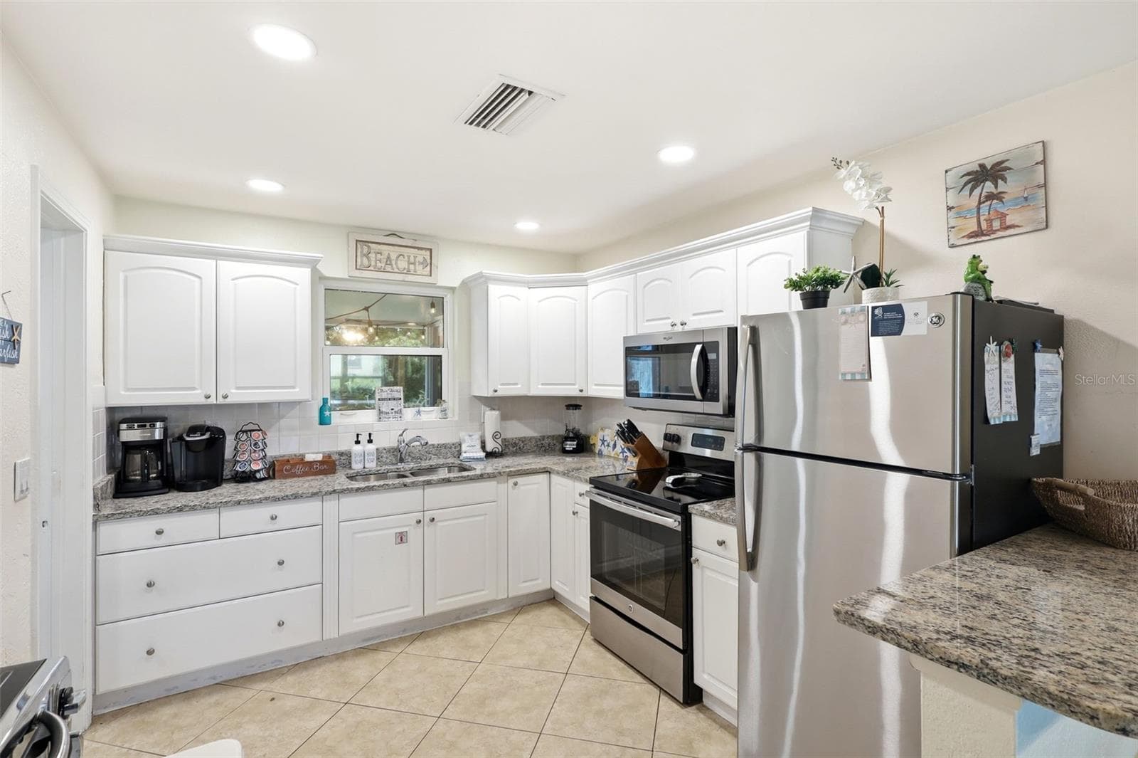 Kitchen. White cabinets, granite, and stainless appliances - 159 LAURIE DR, ORMOND BEACH