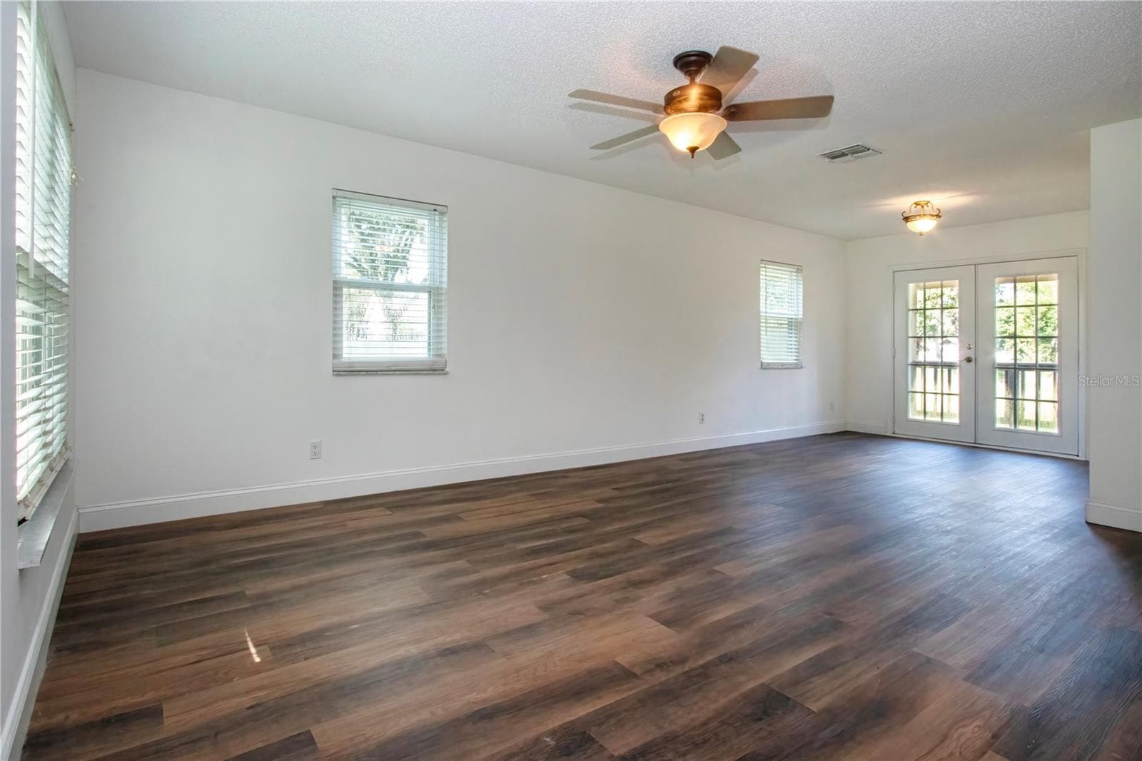 Living room with view of French Doors to the back porch - 2501 LIGHTFOOT RD, WIMAUMA