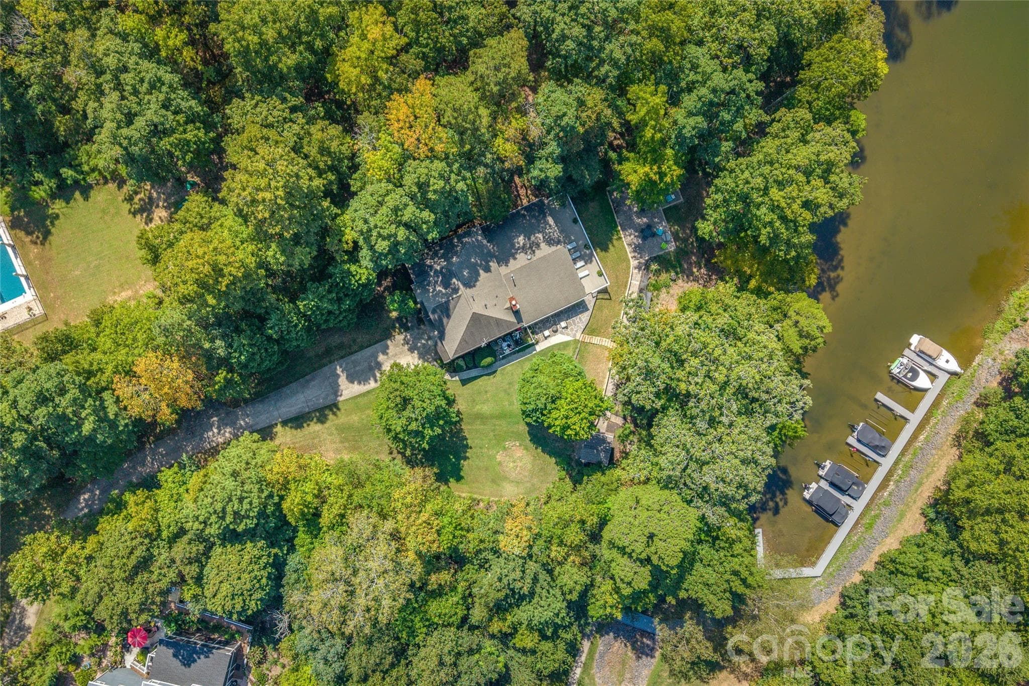 On almost an acre (.95) with mature trees, deeded boat slip, and cove views, this home provides something difficult to find...Privacy - 13934 Kings Carriage Lane, Charlotte