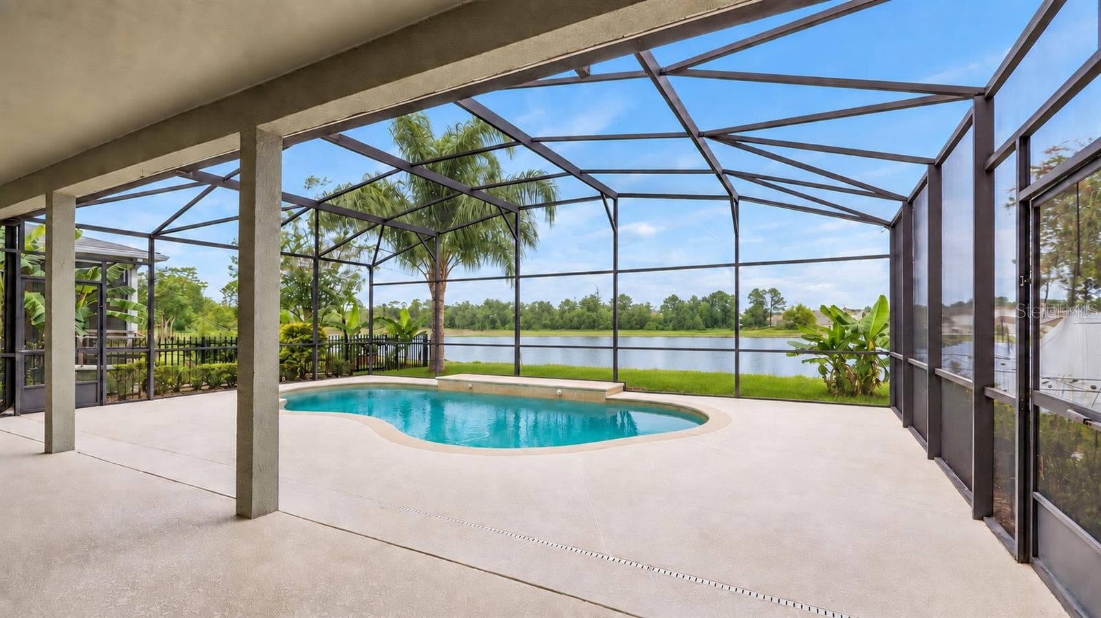 Outside, the covered lanai and screened pool overlook the pond, creating a peaceful setting with no immediate rear neighbors. The outdoor space also includes a built in grill and partially fenced backyard. - 14585 CHEEVER ST, ORLANDO