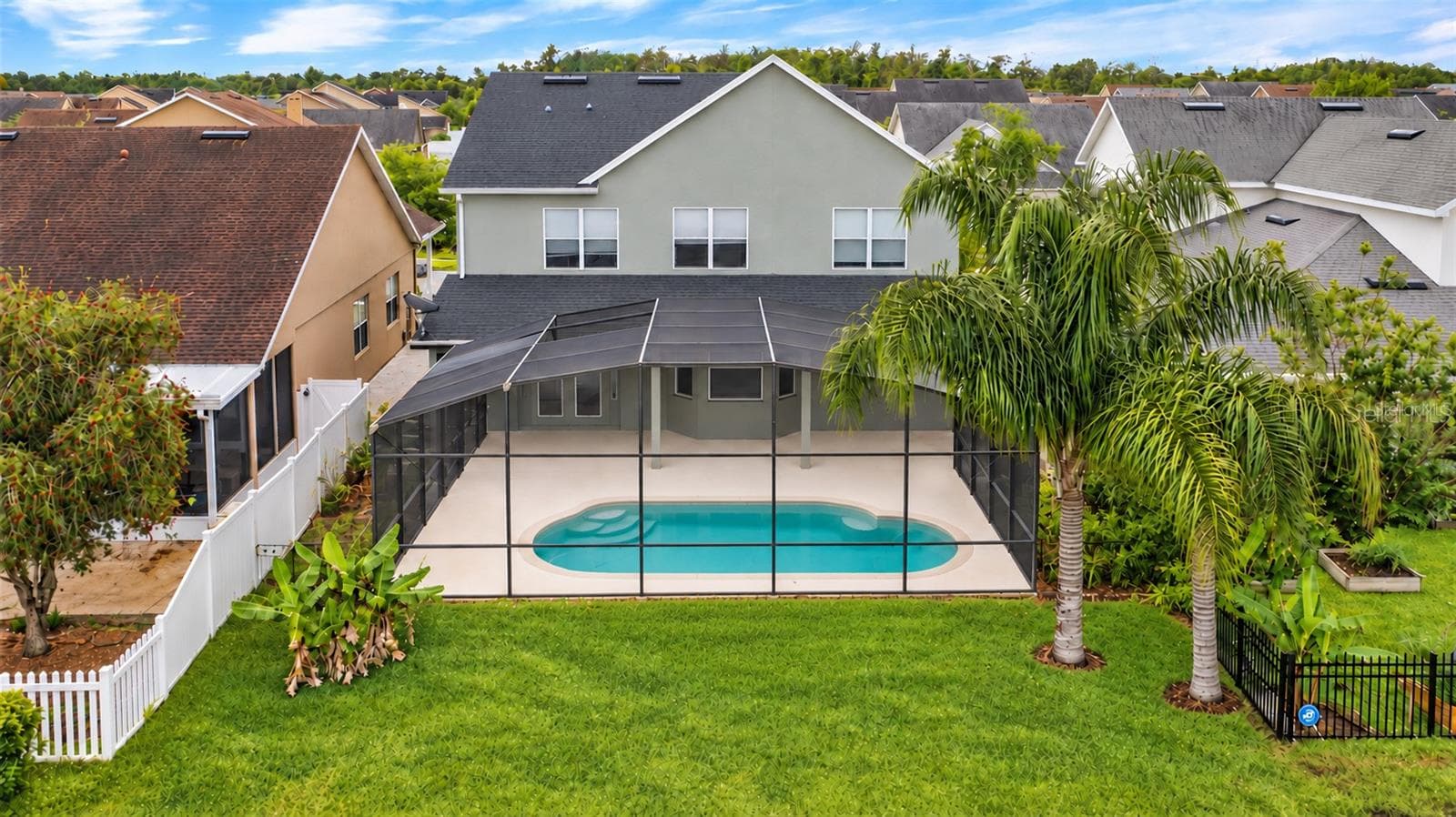Outside, the covered lanai and screened pool overlook the pond, creating a peaceful setting with no immediate rear neighbors. The outdoor space also includes a built in grill and partially fenced backyard. - 14585 CHEEVER ST, ORLANDO