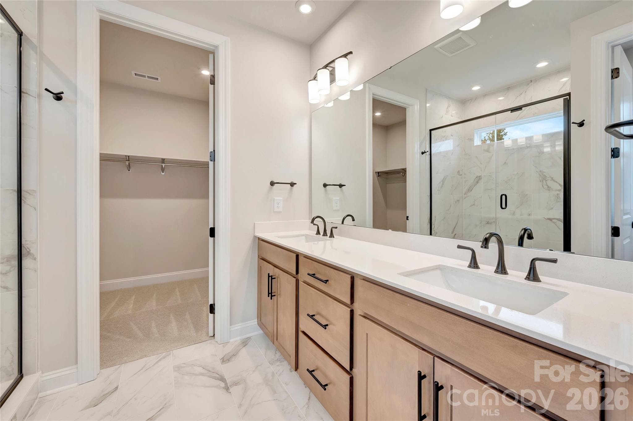 Primary dual vanity bathroom with a walk-in closet - 444 Old Town Village Road, Waxhaw