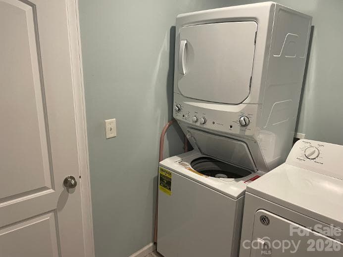 Stackable washer & dryer remain in the home with the sale - tucked away in the Primary Closet - 1670 Dale Earnhardt Boulevard, Kannapolis