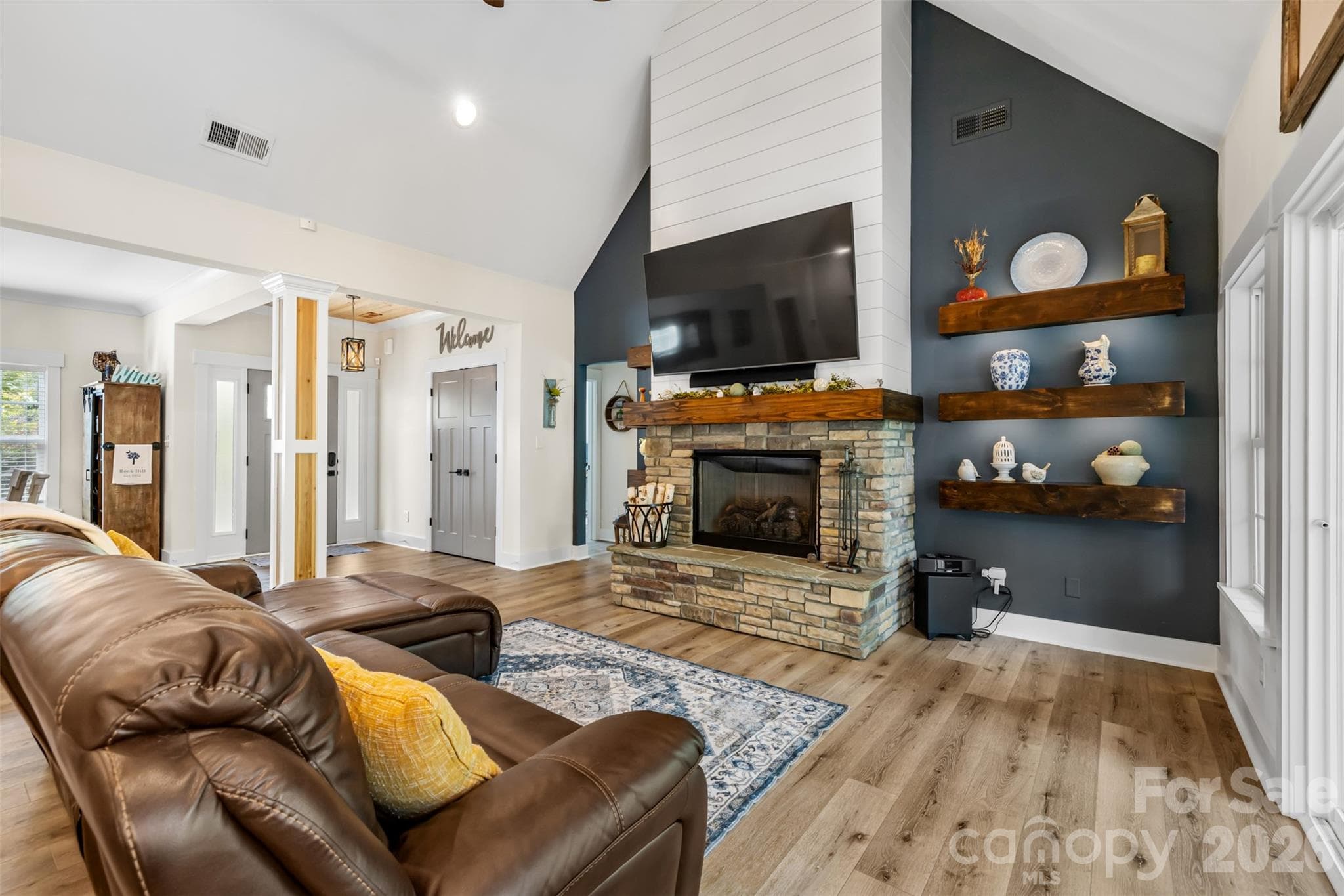 Soaring ceilings and a beautiful stone fireplace create a cozy focal point - 1604 Aragon Beach Road, Rock Hill