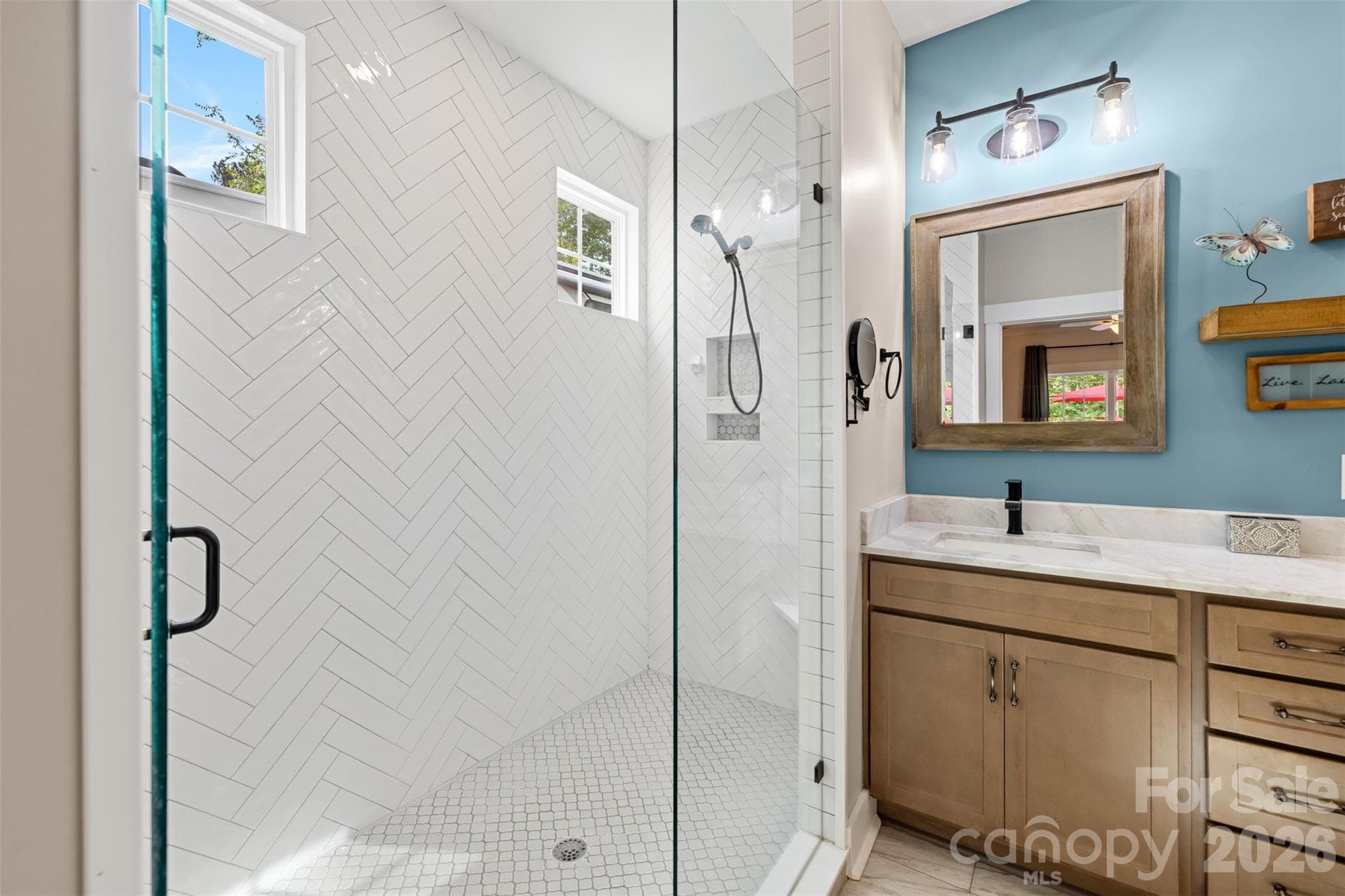 Beautifully updated bath with a large herringbone-tiled shower - 1604 Aragon Beach Road, Rock Hill
