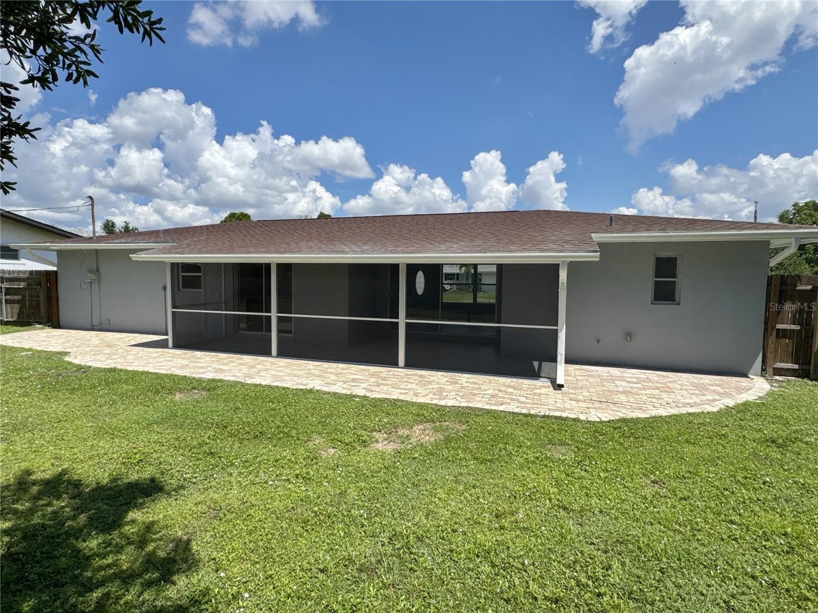exterior rear view showing paver patio as well - 322 READING ST NW, PORT CHARLOTTE