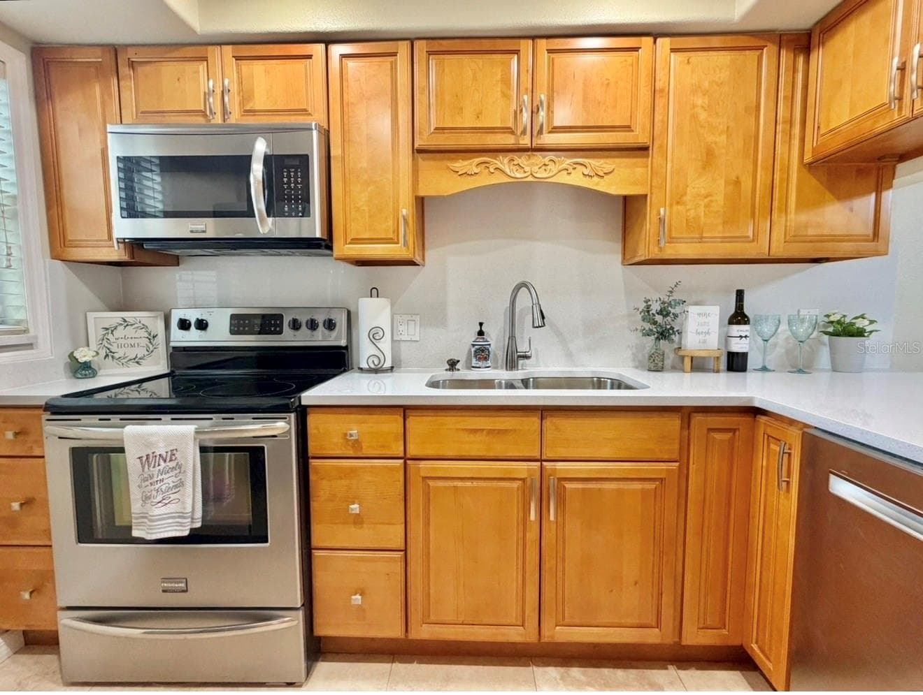 The Kitchen features brand new quartz countertops installed Sept 2026....solid wood cabinets, a brand new sink and faucet, updated lighting, stainless appliances, and travertine floors. - 3815 N OAK DR #G71, TAMPA