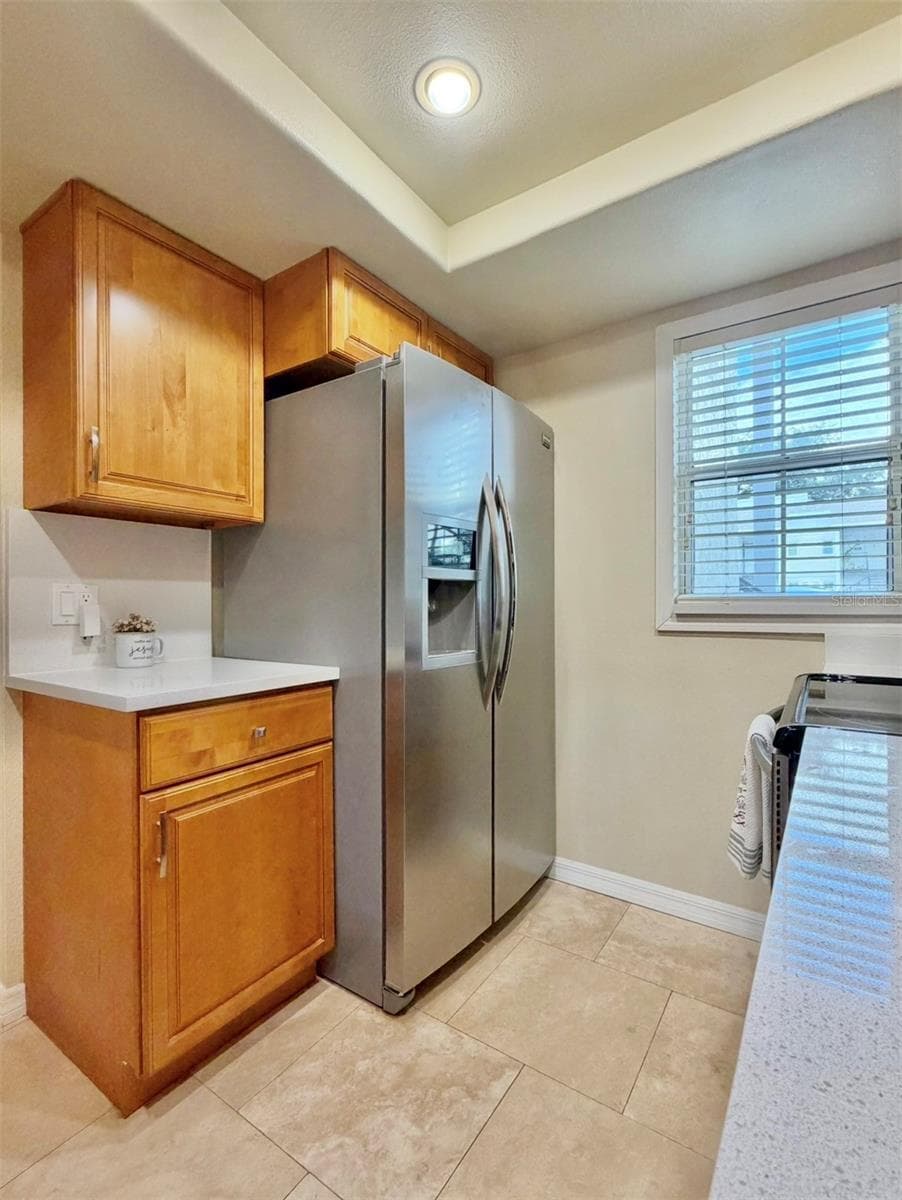 There's extra counter and cabinet space next to the refrigerator. - 3815 N OAK DR #G71, TAMPA
