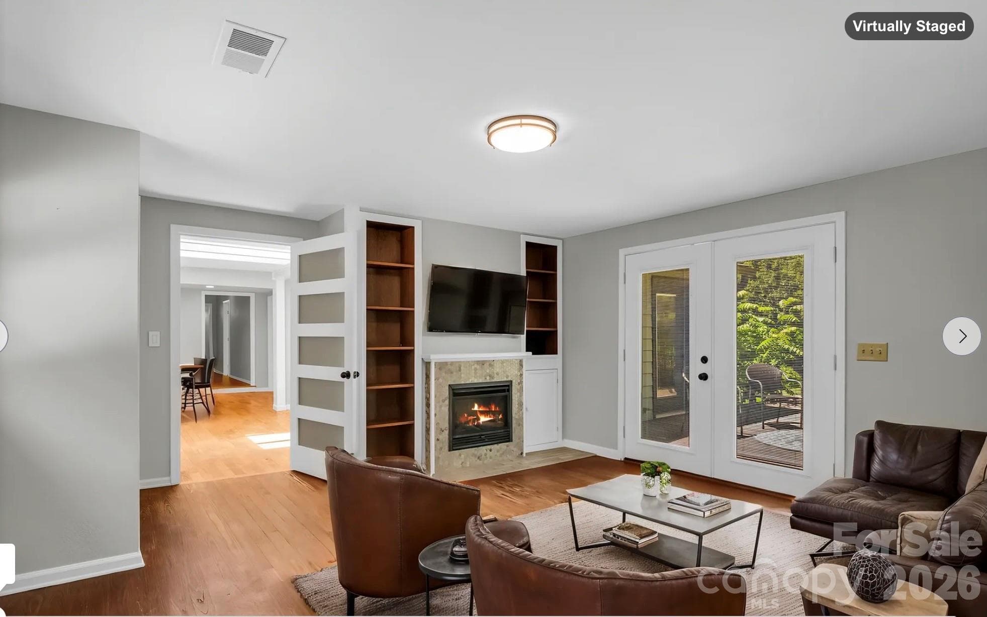 Family Room off of Living Room, with gas logs fireplace (virtually staged & fire digitally added) - 35 Chastain Hill Road, Mills River