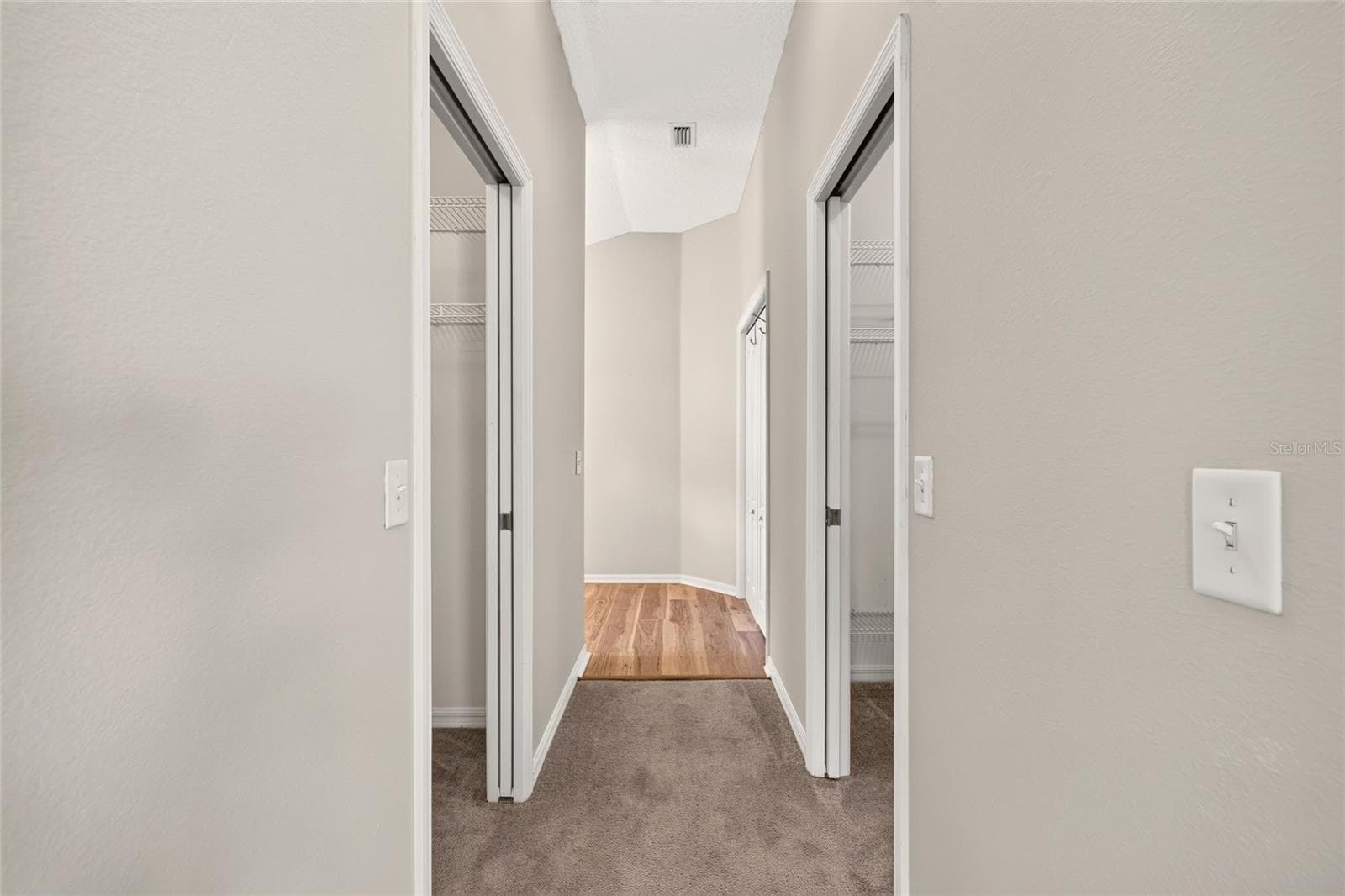 His and hers closets between the bedroom and primary bathroom - 17101 SE 94TH BERRIEN CT, THE VILLAGES