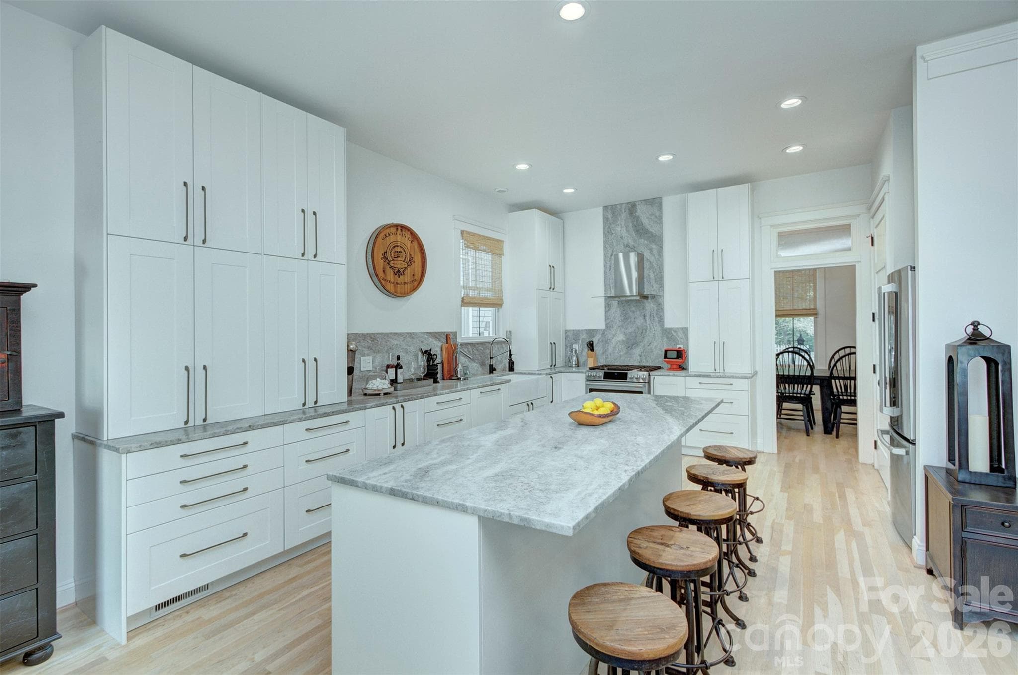 Gorgeous custom leathered marble counter tops, backsplash and striking 7 ft slab behind range - 2561 Lower Assembly Drive, Fort Mill