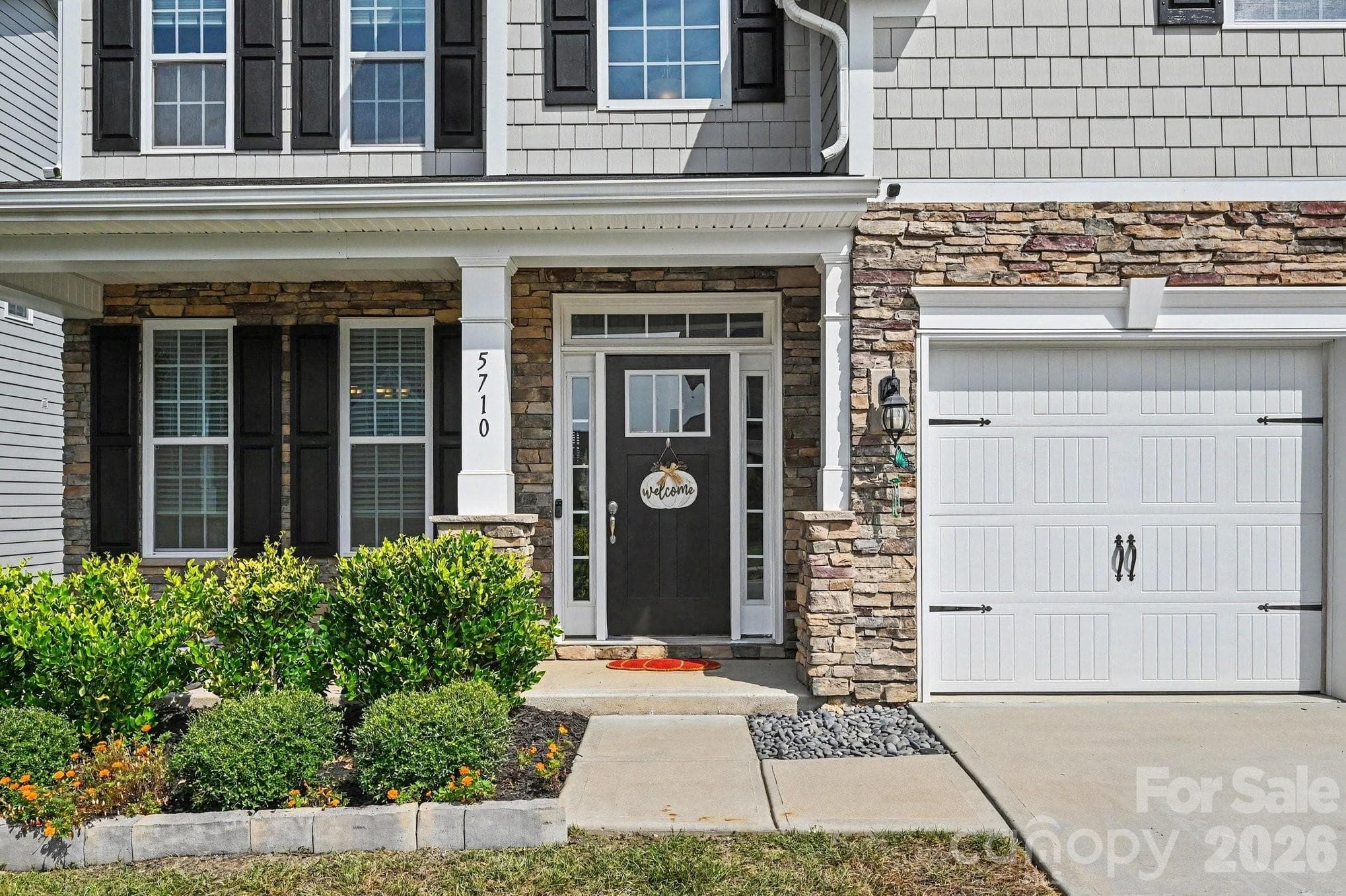 Welcoming covered front entry with attractive stone accents - 5710 Rainbow Lane, Indian Land