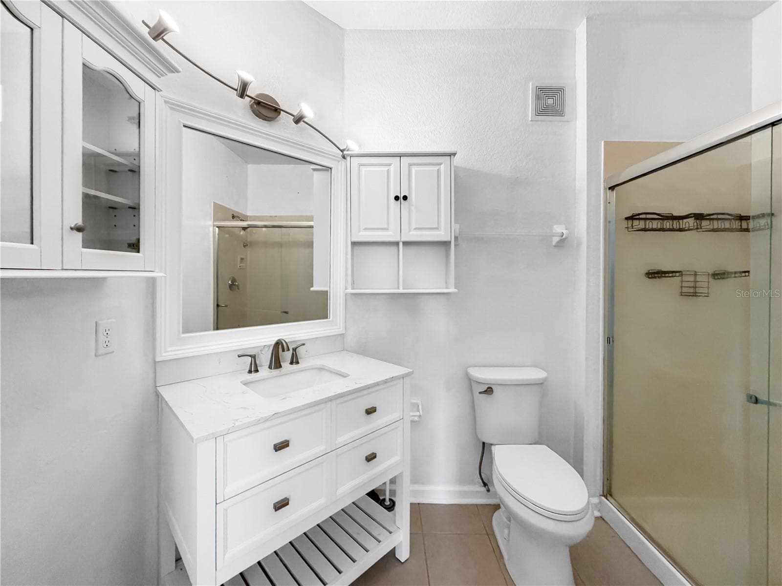 Ensuite bathroom with cabinets and walk-in shower. - 6434 CAVA ALTA DR #105, ORLANDO