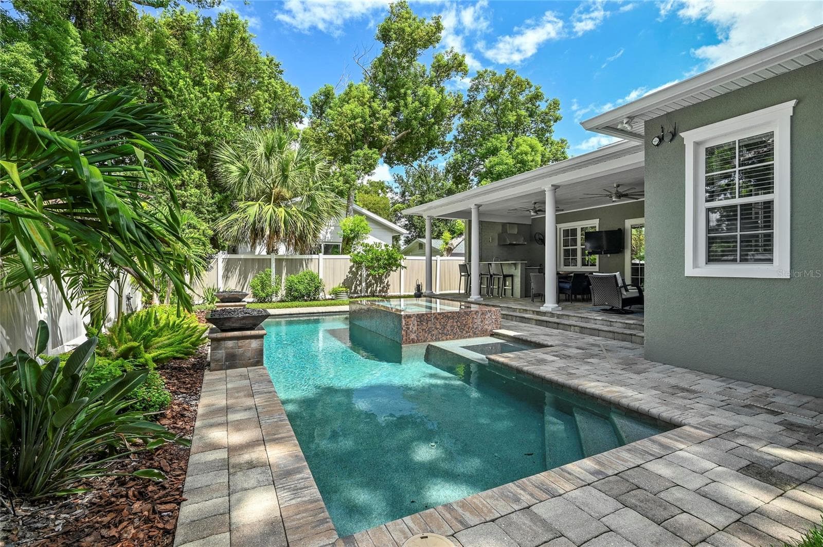 The salt water pool features a heated spill-over spa and paver deck. - 1951 WINTER PARK RD, WINTER PARK