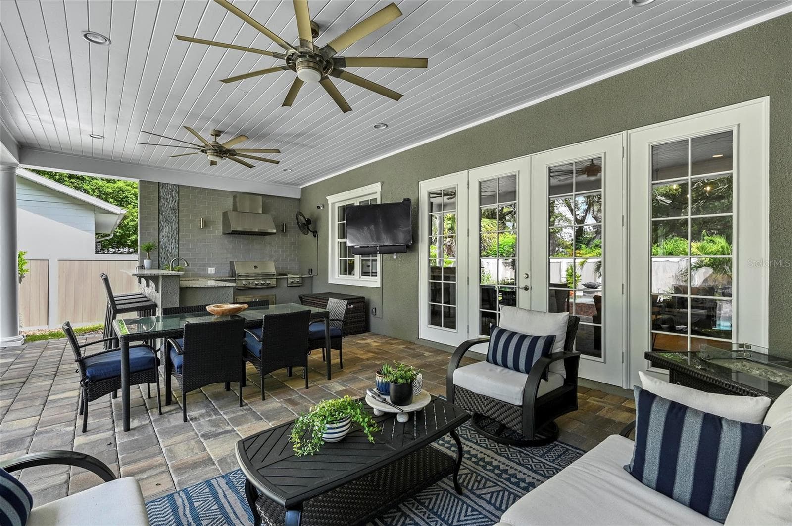 The back patio is a stunning living area providing room for seating, dining, cooking and entertaining, with the heavenly and lush landscape being reflected on all sides. - 1951 WINTER PARK RD, WINTER PARK