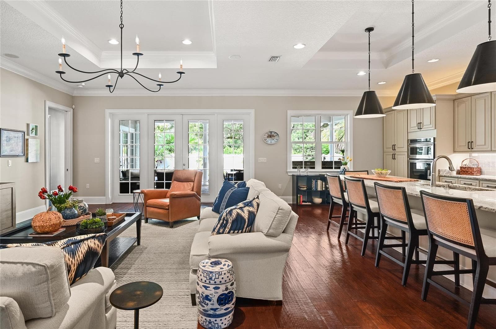 The interior living area flows seamlessly to the backyard oasis, with views through expansive French doors. - 1951 WINTER PARK RD, WINTER PARK