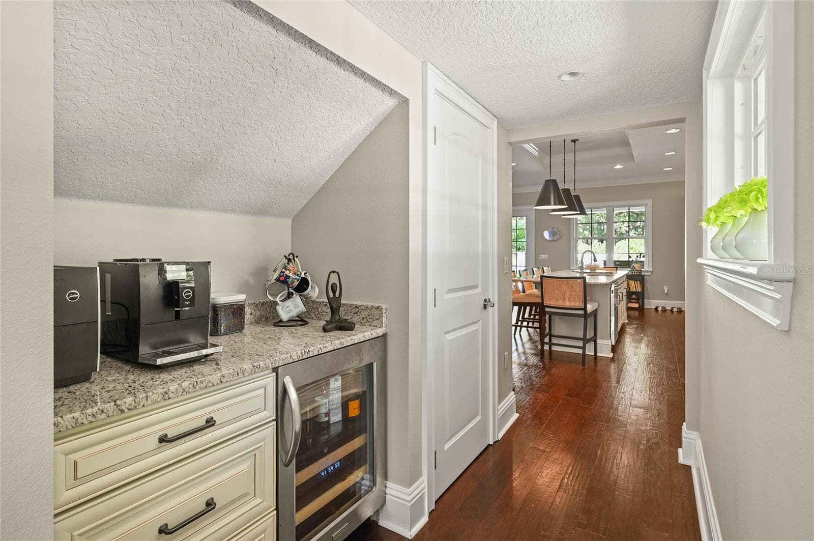 There is a coffee bar and wine fridge tucked in next to the kitchen. - 1951 WINTER PARK RD, WINTER PARK