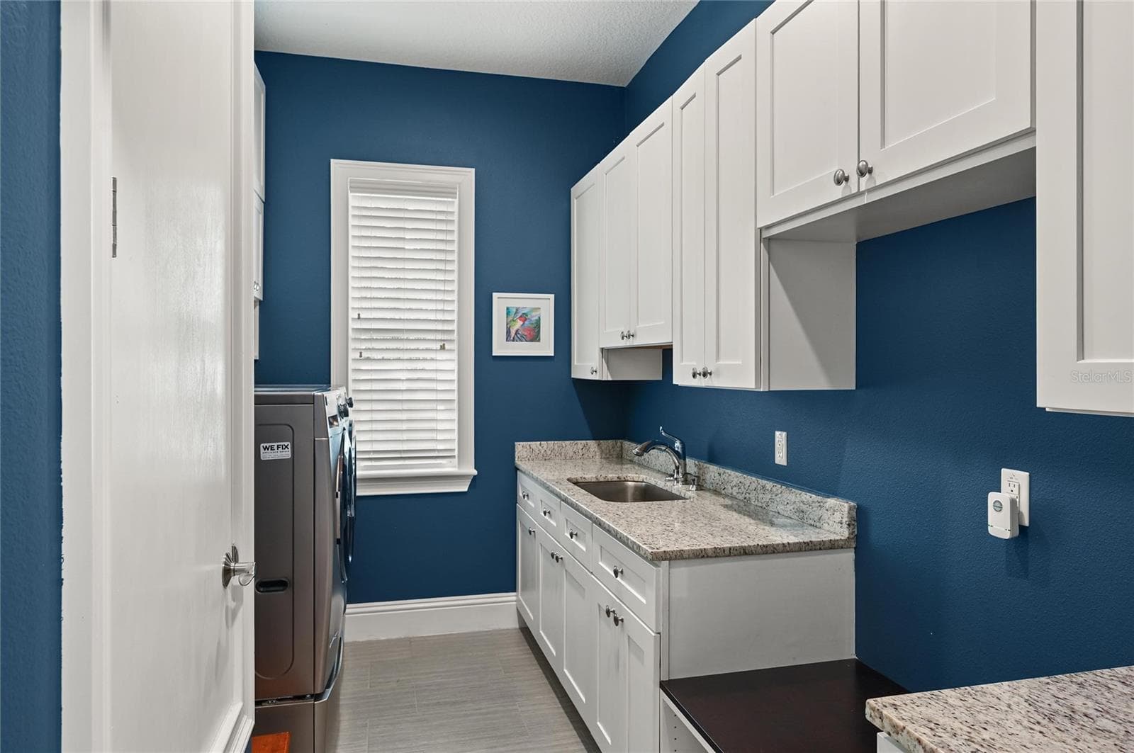 Natural light fills the laundry area, complete with sink and an abundance of storage. - 1951 WINTER PARK RD, WINTER PARK
