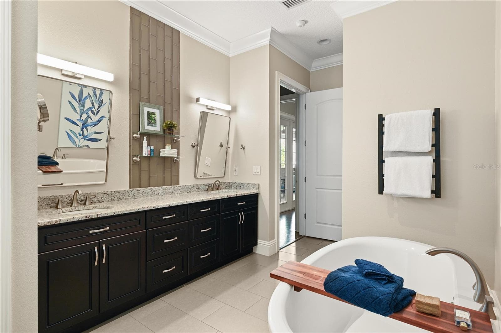 The master suite features 8-foot doors, a large linen closet, double sinks as well as dual shower heads and a hard-wired towel warming rack. - 1951 WINTER PARK RD, WINTER PARK