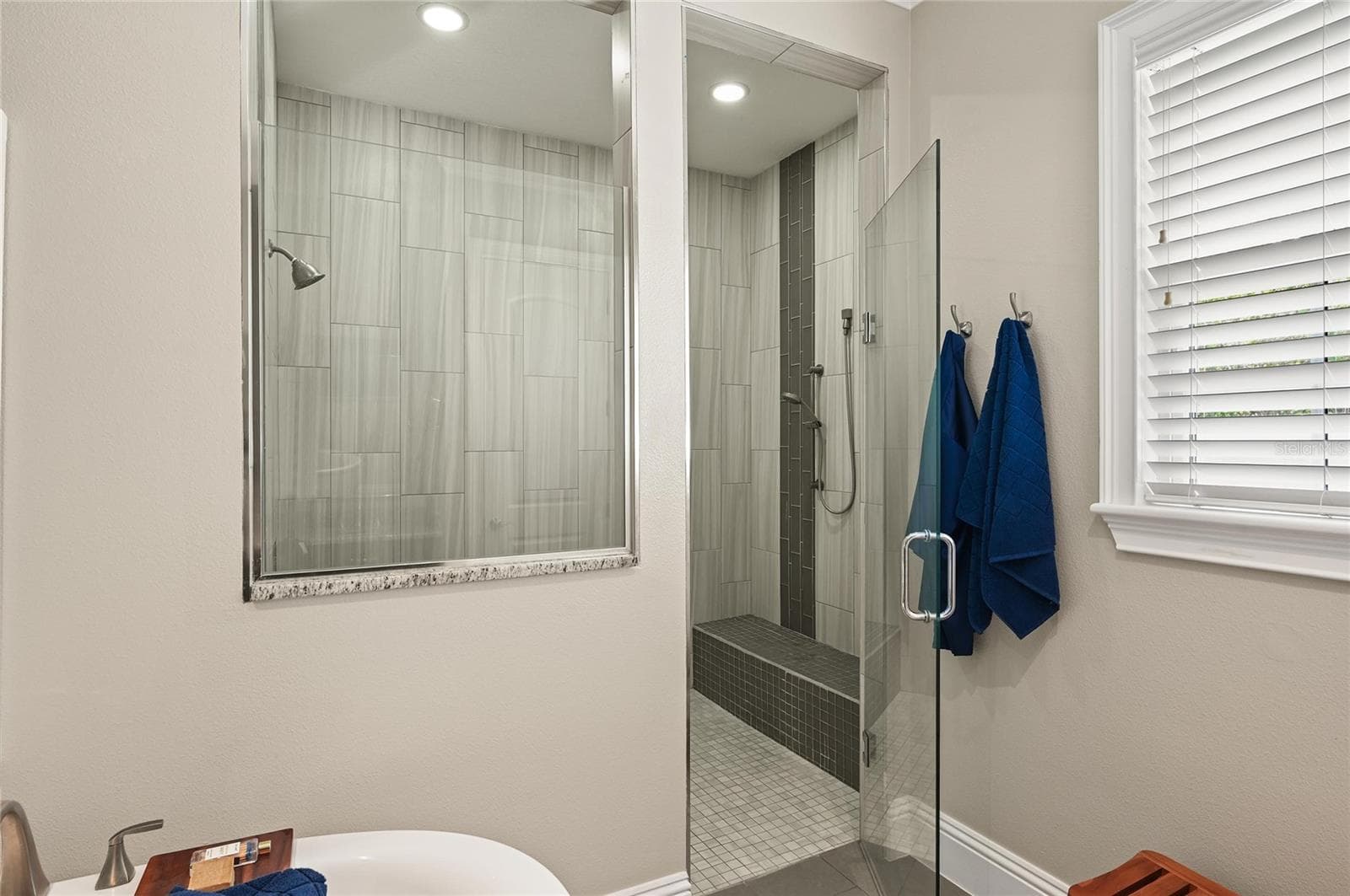 The oversized shower was thoughtfully designed with a handy bench seat and controls located just inside the shower opening. - 1951 WINTER PARK RD, WINTER PARK