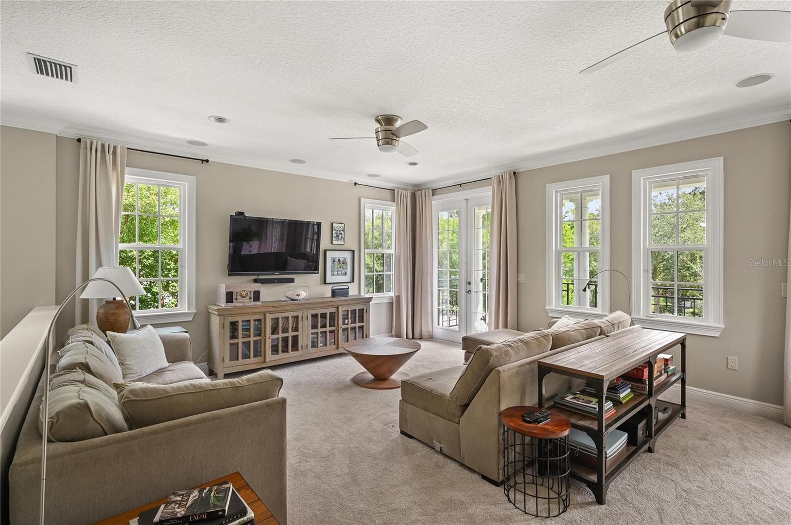 Double french doors let the light in and show off the surrounding tree canopy. - 1951 WINTER PARK RD, WINTER PARK