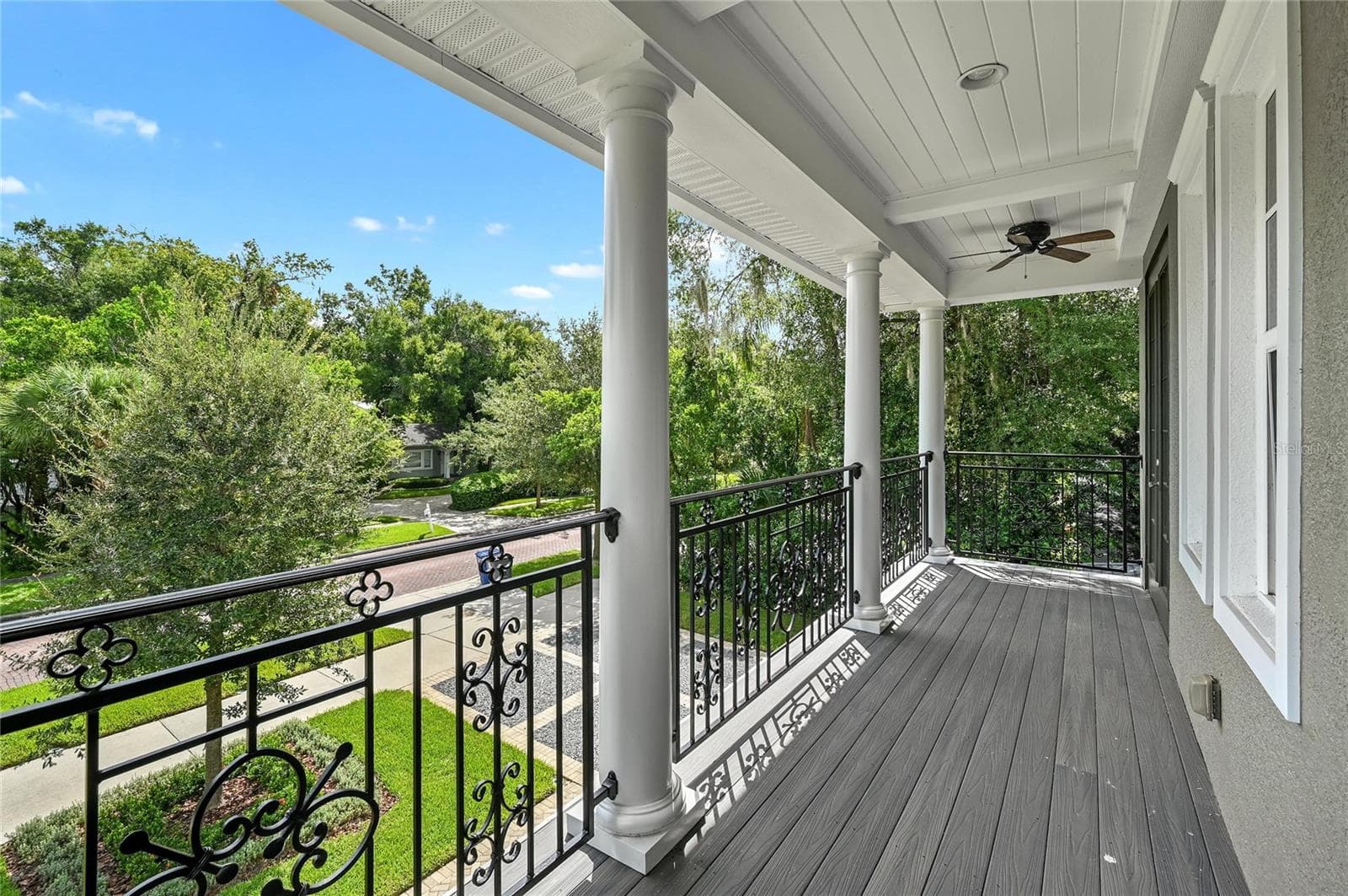 The upper porch is a taste of Southern charm, complete with fans and iron-rail detailing. - 1951 WINTER PARK RD, WINTER PARK