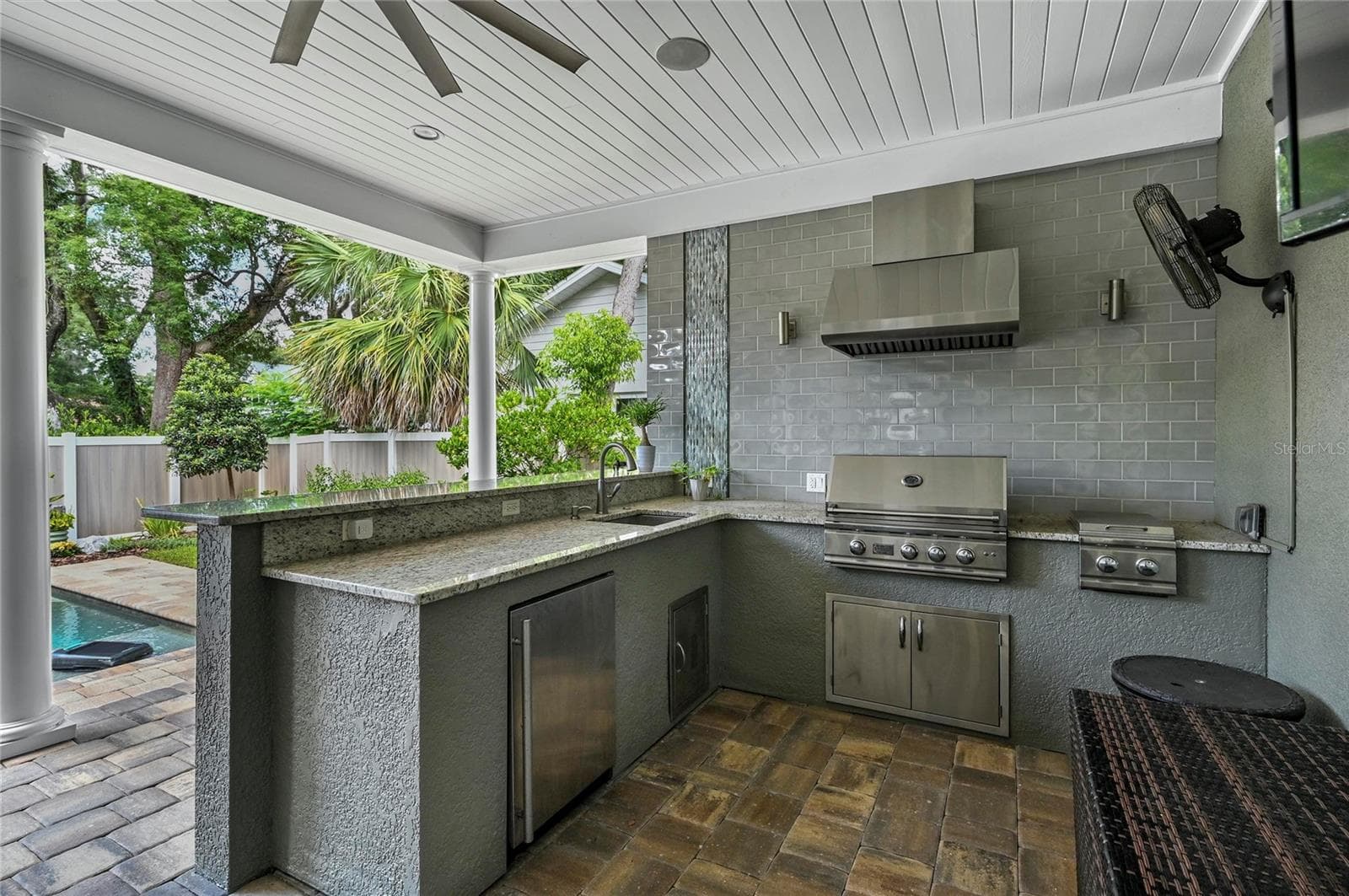 Cooks will love the professional gas grill with hood, side burner, a deep sink, and loads of stone counter space. Grab a drink from the fridge while you are sitting by the pool! - 1951 WINTER PARK RD, WINTER PARK