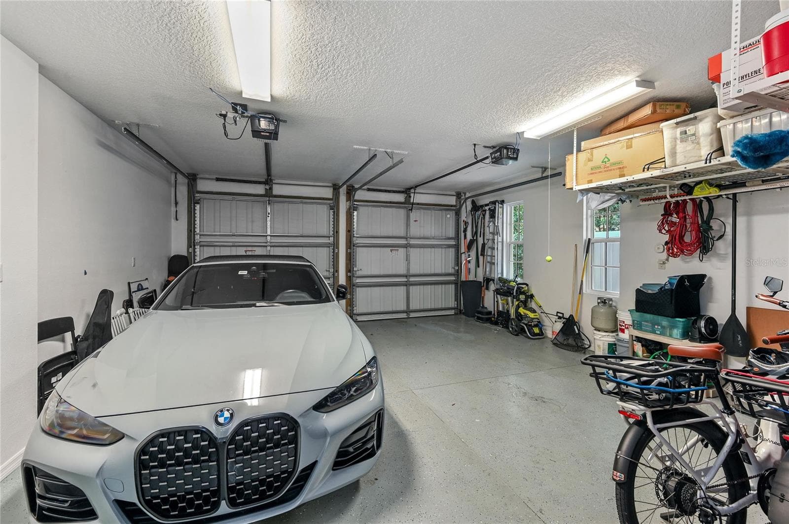 The two-car garage features heavy-duty, ceiling mounted storage. - 1951 WINTER PARK RD, WINTER PARK
