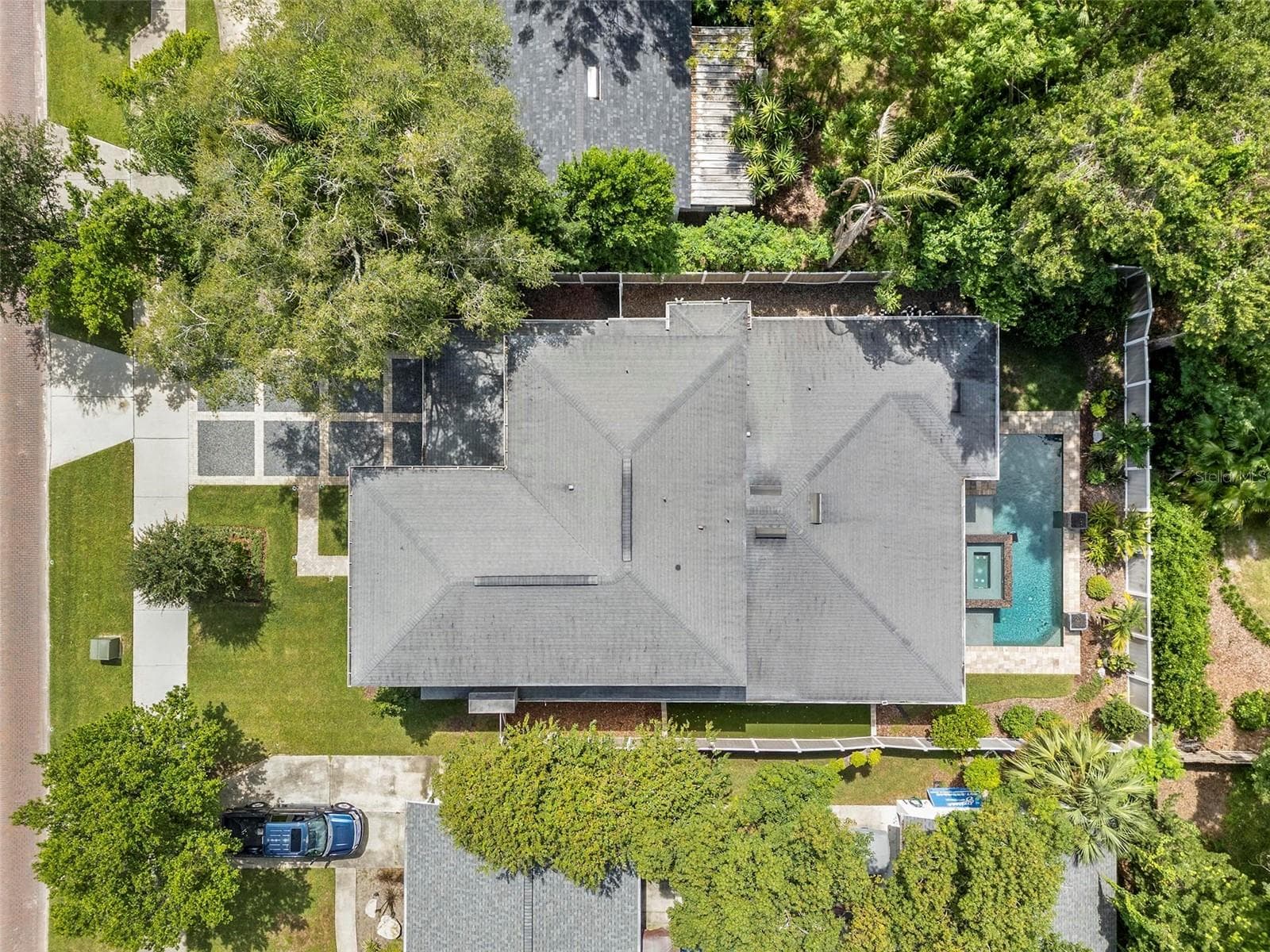 The home is surrounded by lush, mature trees. - 1951 WINTER PARK RD, WINTER PARK