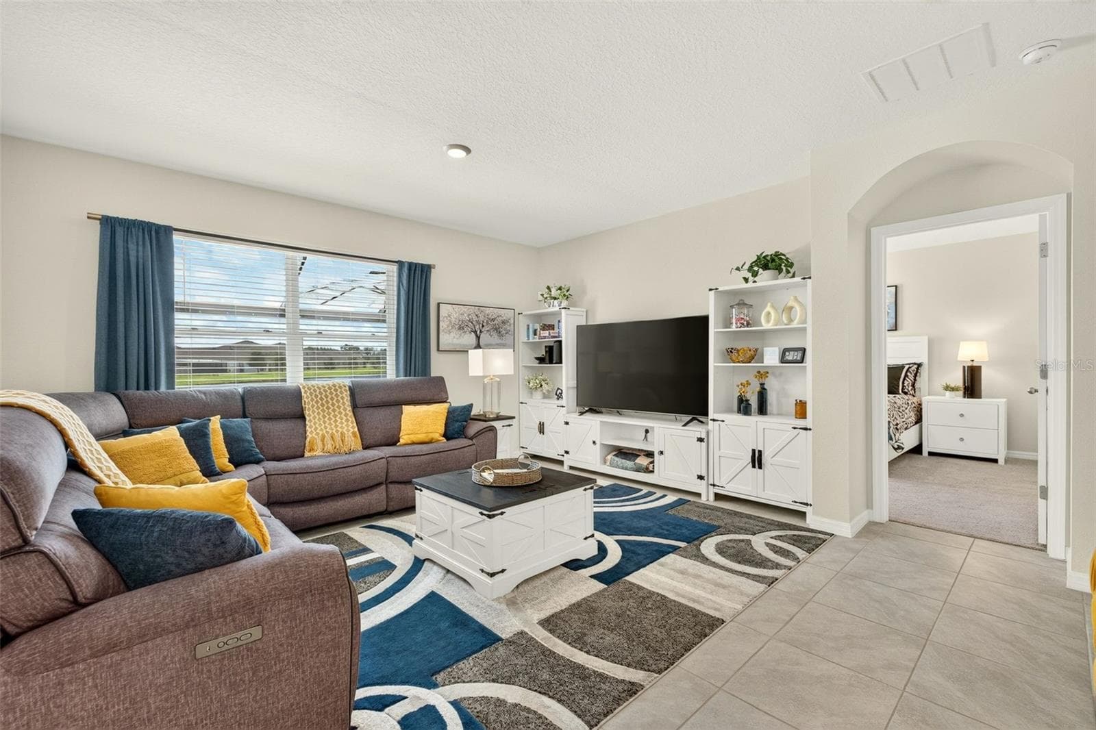 Bright and spacious great room, open to the kitchen and view of the pool area - 17206 RESERVA DR, BRADENTON
