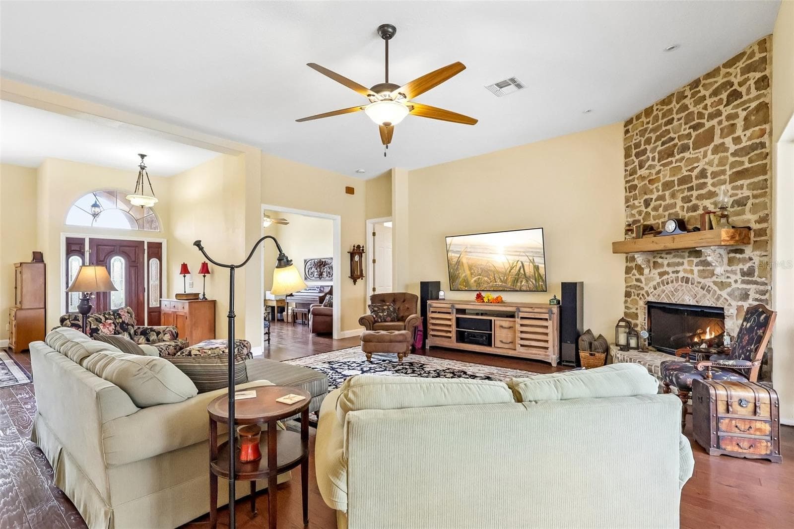 Living Room with stone fireplace - view of entry and front office - 32736 WOLFS TRL, SORRENTO