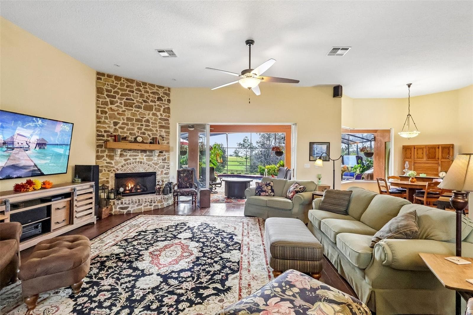 Beautiful stone fireplace - rear faces east so you have beautiful sunrises to enjoy as you sip your morning coffee - 32736 WOLFS TRL, SORRENTO