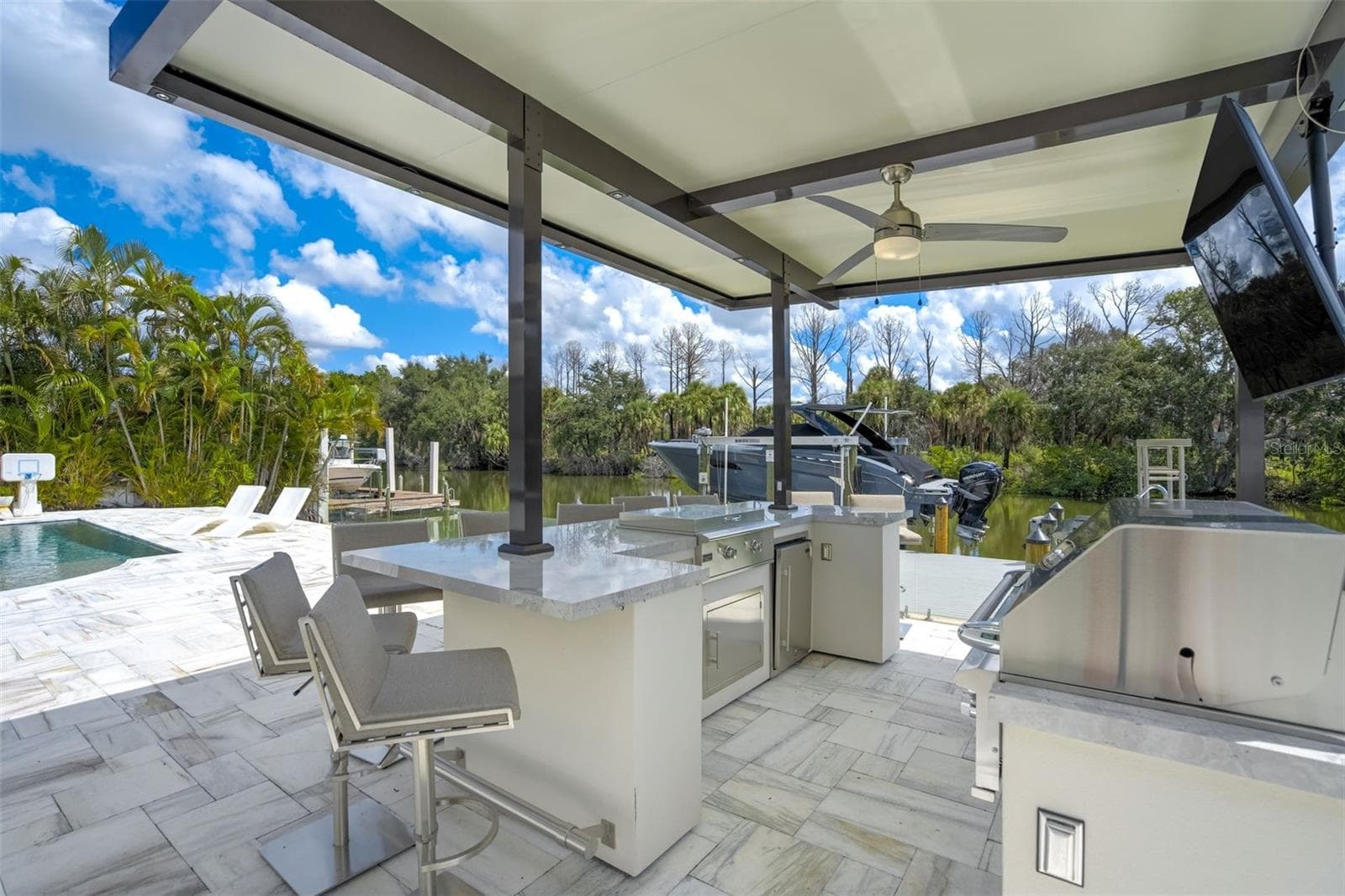 Outdoor kitchen with gas grill, griddle, multiple beverage coolers, and speaker system - 3923 DORAL DR, TAMPA