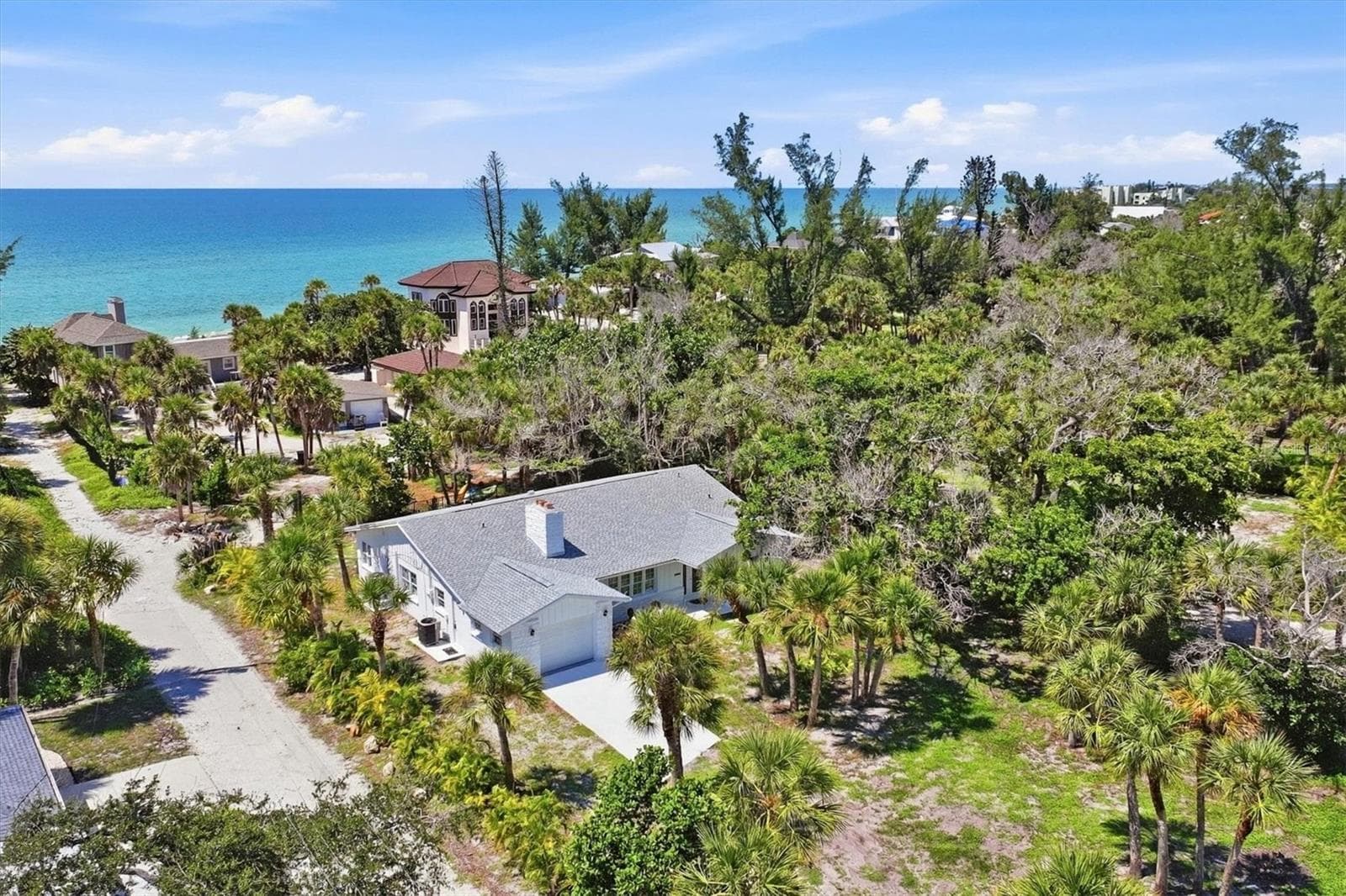 to the left of the home you'll see the private easement/walkway to the Gulf - 3050 N BEACH RD, ENGLEWOOD