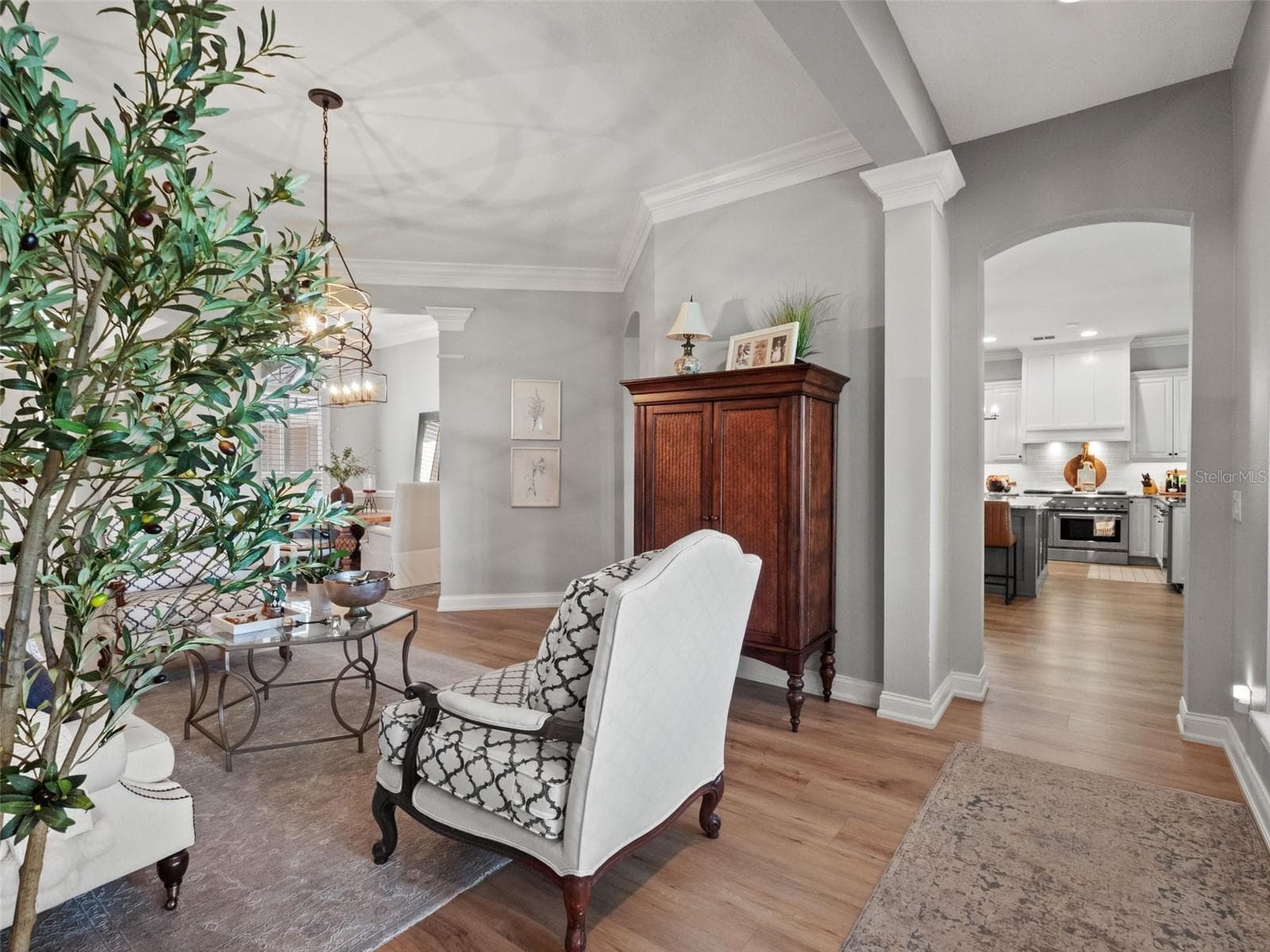 Formal living room looking from primary bedroom into kitchen - 25535 HAWKS RUN LN, SORRENTO