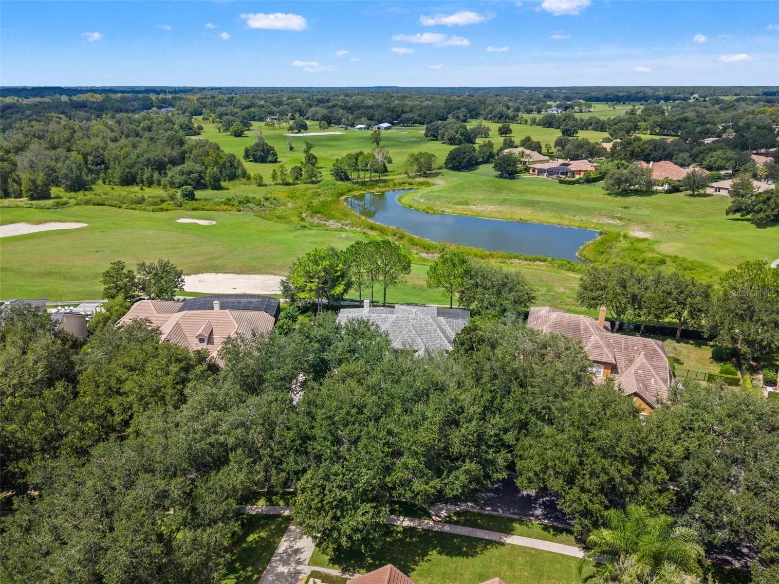 House looking over the golf course, pond, and horse pastures in the distance - 25535 HAWKS RUN LN, SORRENTO