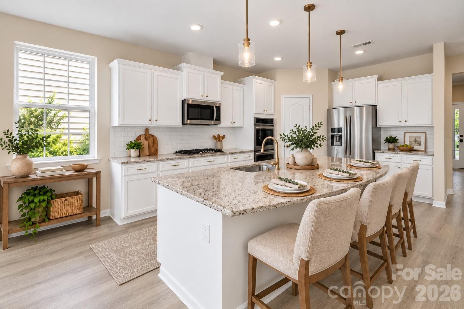 Beautifully appointed kitchen featuring a generous center island, abundant cabinetry, and stainless steel appliances - 2015 Kensley Drive, Waxhaw