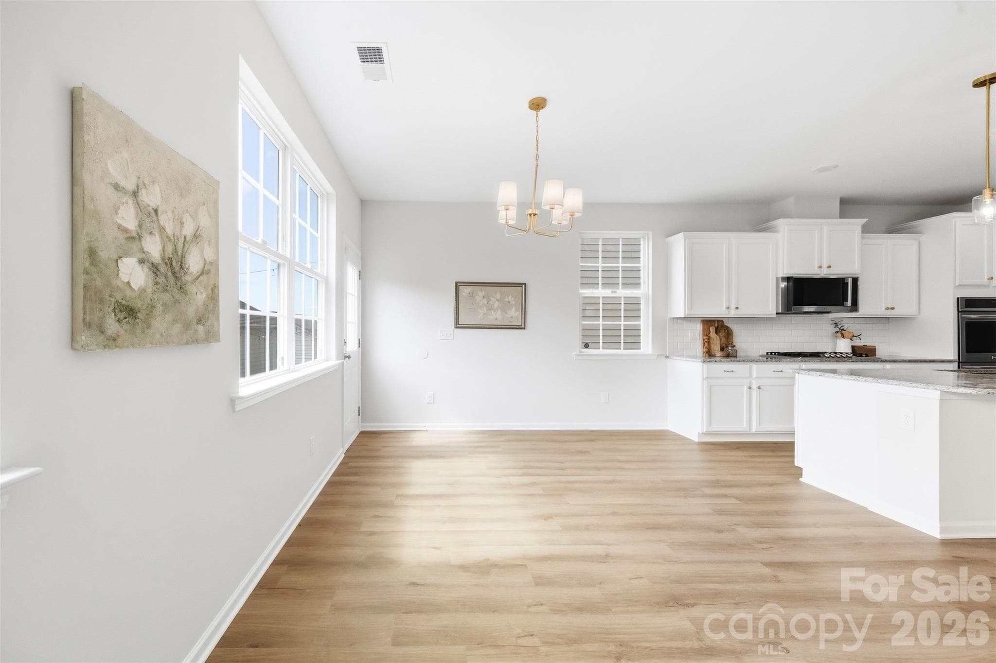Open-concept kitchen, living, and dining area flow seamlessly together, creating an ideal layout for everyday living and entertaining - 2015 Kensley Drive, Waxhaw
