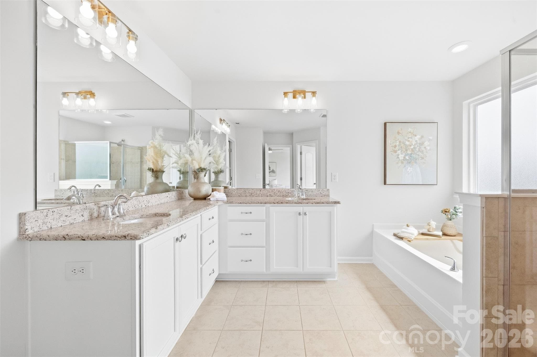 Updated primary bath is enhanced by stylish new lighting and fixtures for a fresh, polished look - 2015 Kensley Drive, Waxhaw