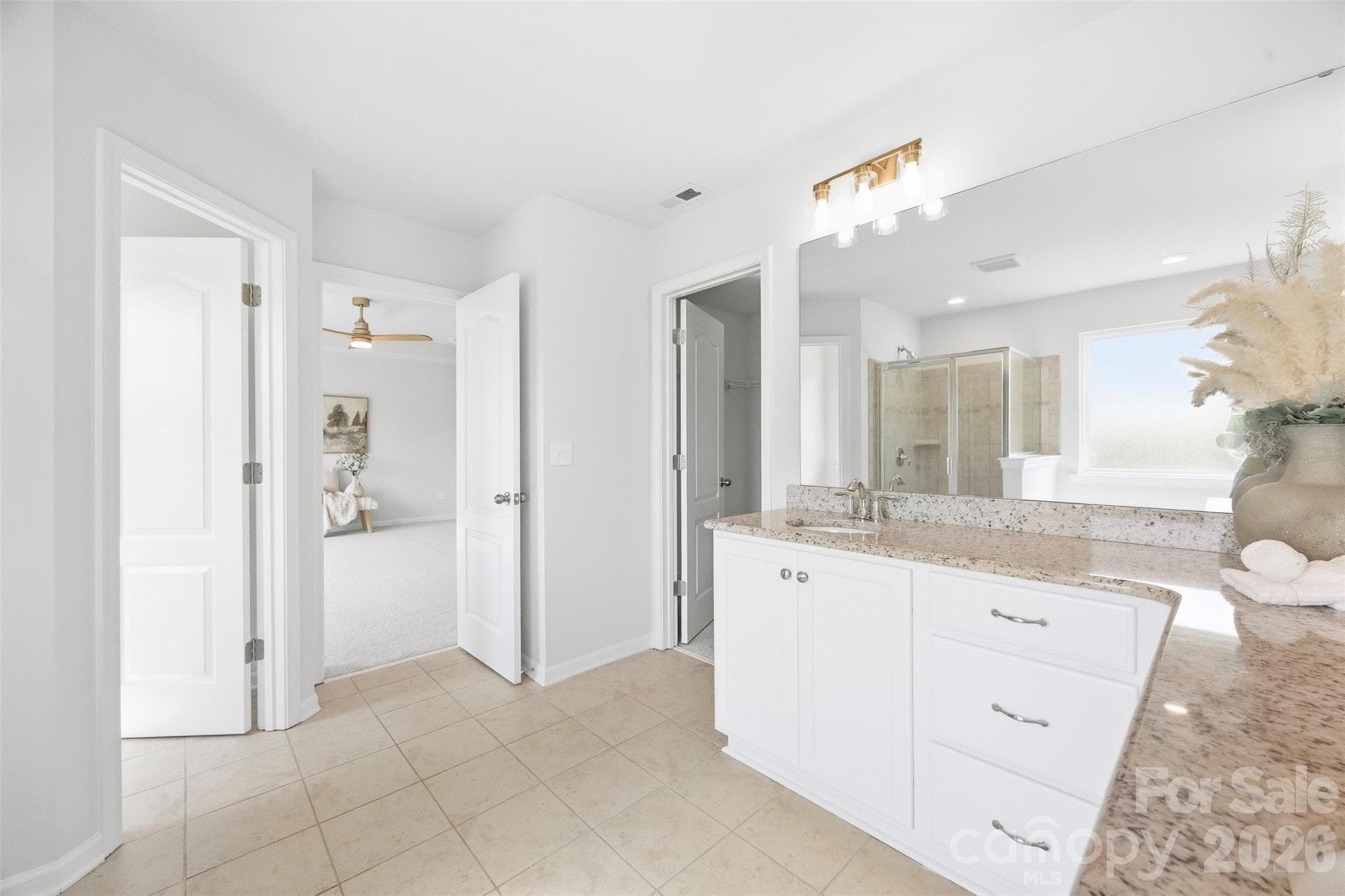 Thoughtfully designed primary bath offers abundant vanity storage and easy access to the walk-in closet and bedroom - 2015 Kensley Drive, Waxhaw