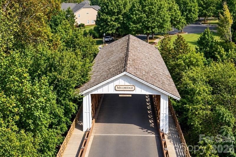 MillBridge’s iconic covered bridge over Twelve Mile Creek creates a memorable entrance and reflects the community’s distinctive small-town character - 2015 Kensley Drive, Waxhaw