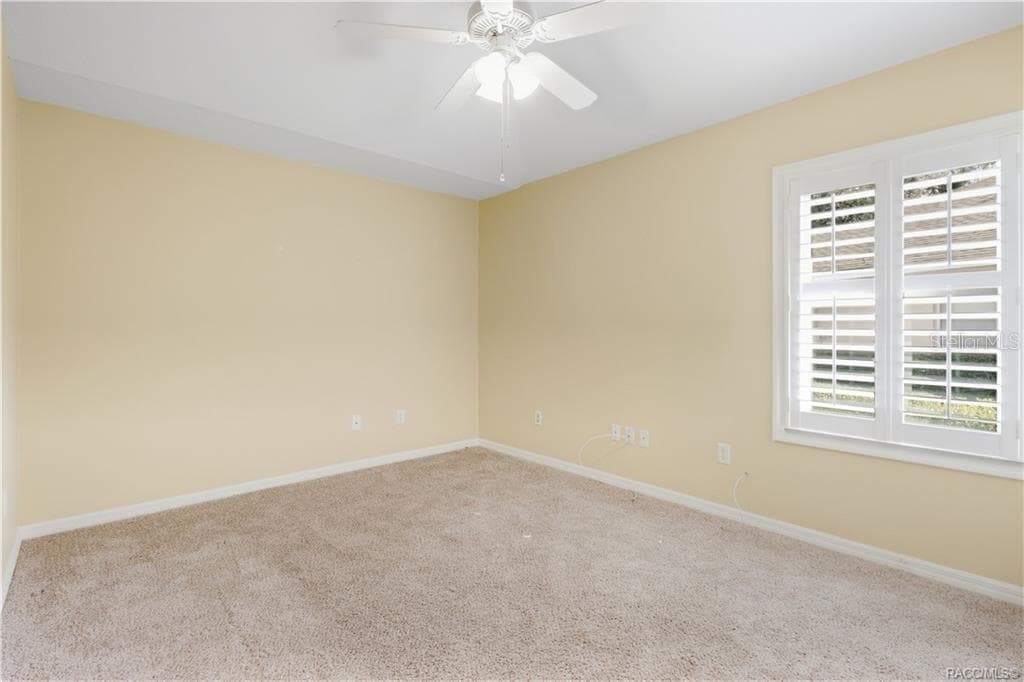 BEDROOM 2 – Guest bedroom featuring ceiling fan & window with plantation shutters. - 6410 W CANNONDALE DR, CRYSTAL RIVER