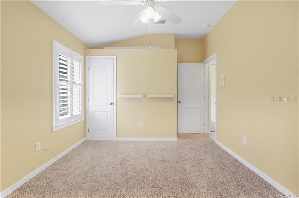 BEDROOM 2 – Alternate view showing the lighted plant shelf, plantation shutters, closet & additional wall shelving. - 6410 W CANNONDALE DR, CRYSTAL RIVER