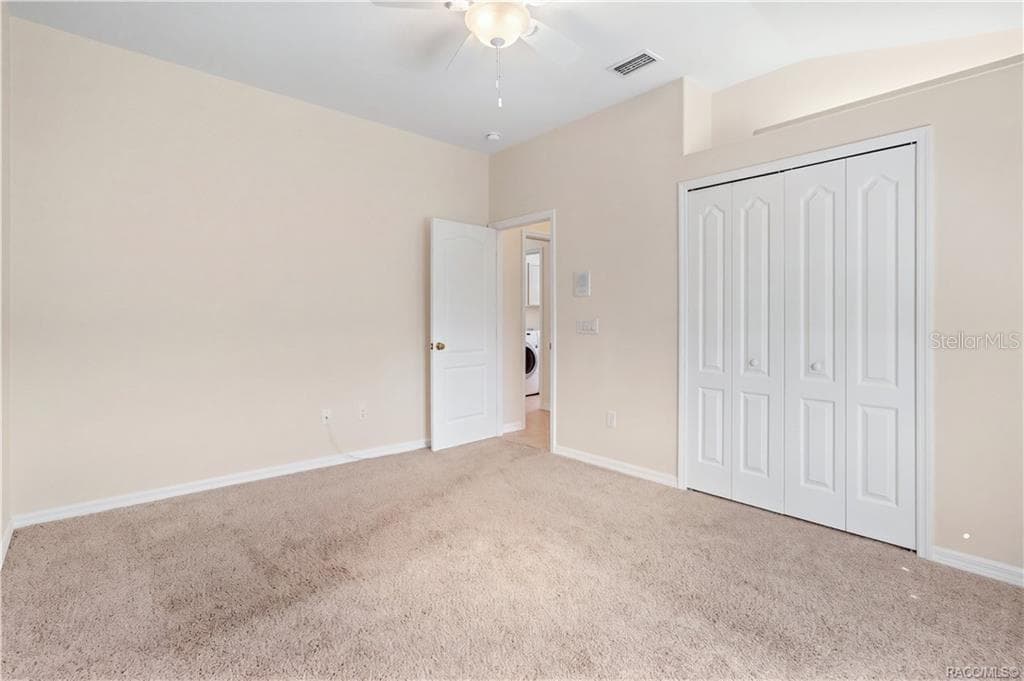 BEDROOM 3 – Alternate view highlighting the double bi-fold closet doors, lighted plant shelf, ceiling fan. - 6410 W CANNONDALE DR, CRYSTAL RIVER