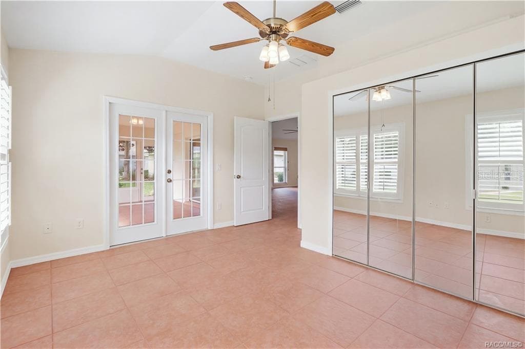 FLEX ROOM / DEN / 4th BEDROOM – Alternate view highlighting mirrored closet doors, French doors entering enclosed Florida room, tile flooring, ceiling fan & plantation shutters. - 6410 W CANNONDALE DR, CRYSTAL RIVER