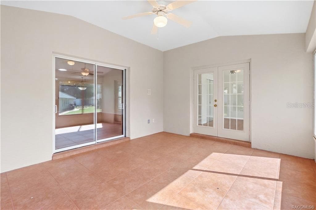 FLORIDA ROOM / BONUS LIVING SPACE – Bright tiled bonus space ceiling fan, French doors entering FLEX /4th Bedroom & sliding-glass doors connecting to the living room. - 6410 W CANNONDALE DR, CRYSTAL RIVER