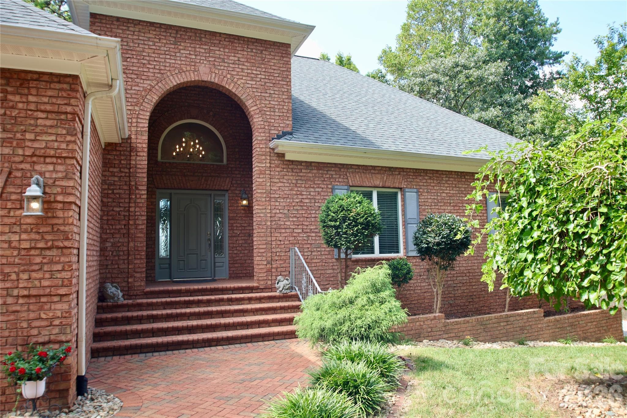 This custom-brick entrance greets you to your new lakefront oasis. - 140 Holt Lane, Mooresville