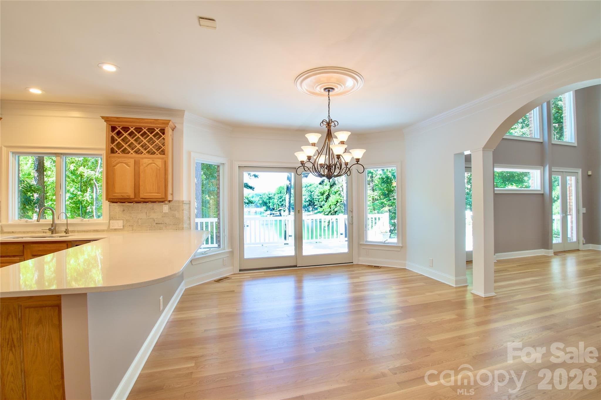 Lakefront dining area with gleaming hardwoods and updated kitchen. - 140 Holt Lane, Mooresville