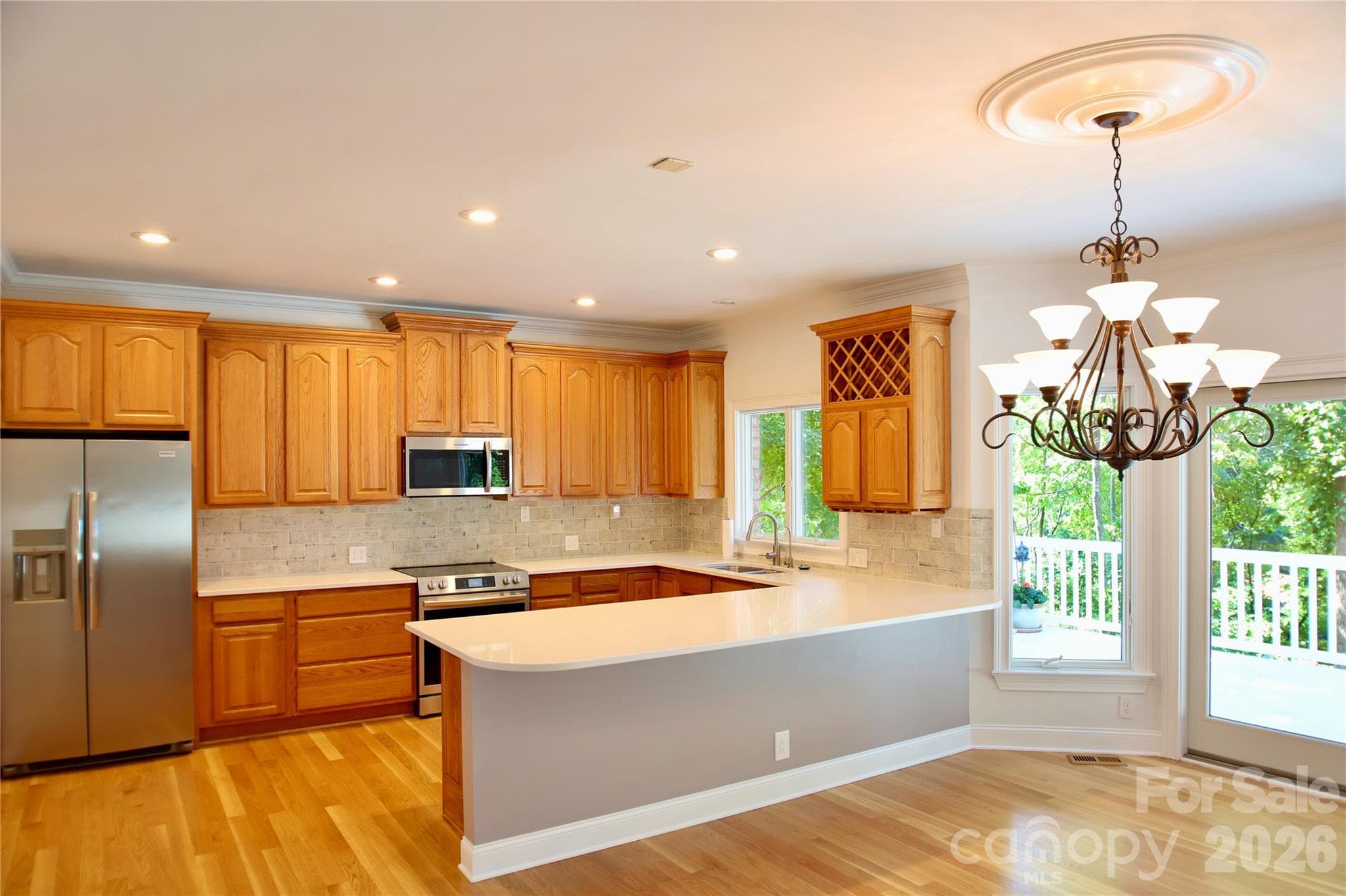 Kitchen features new quartz countertops with subway tile backsplash, new stainless steel appliances including wine cooler. - 140 Holt Lane, Mooresville