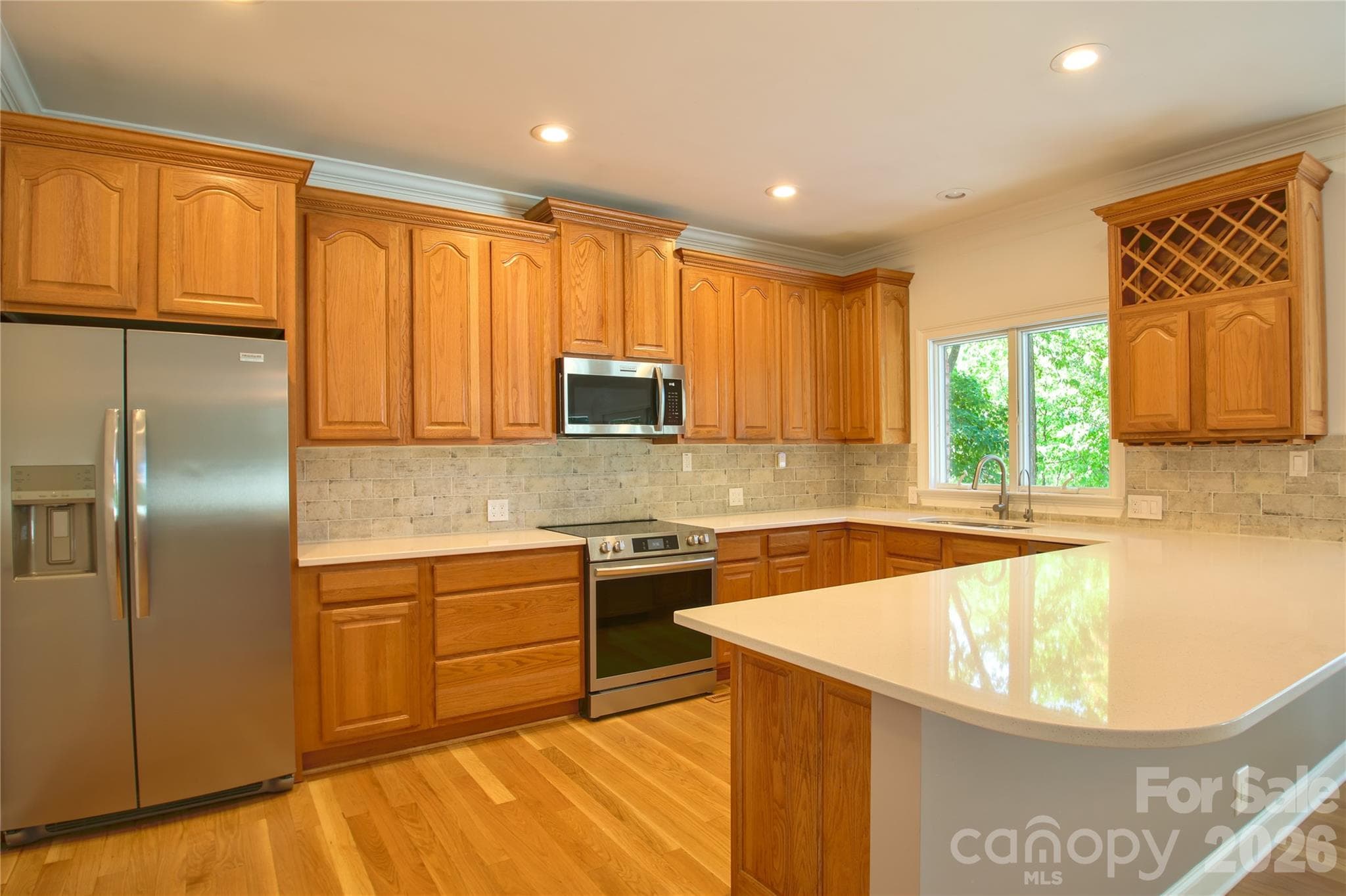 Bright kitchen with lots of cabinets also has a pantry with double doors and a room that was used as an office or could be turned into another pantry/closet. - 140 Holt Lane, Mooresville